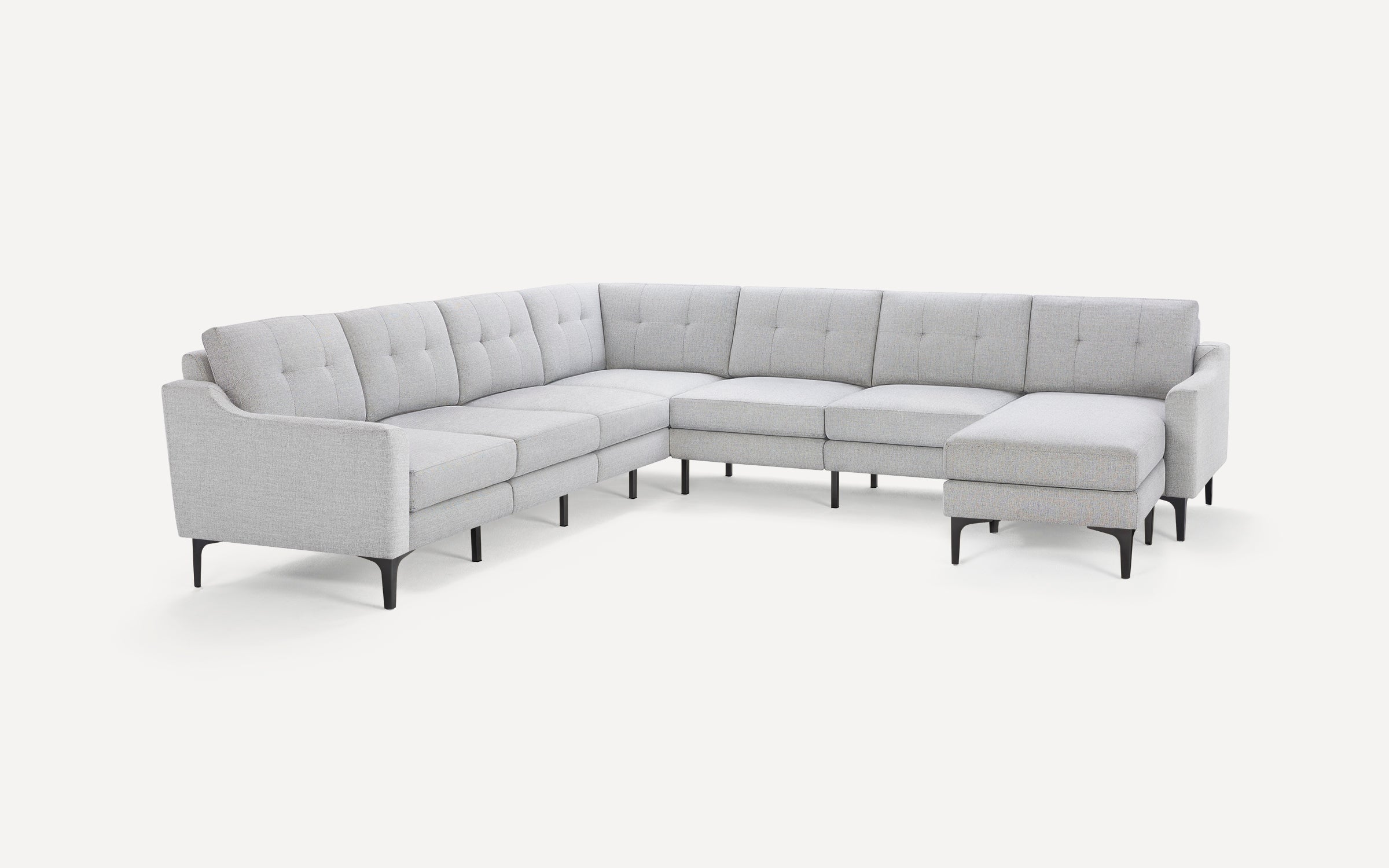 Light gray L-shaped sectional sofa with tufted back cushions and black tapered legs on a white background.