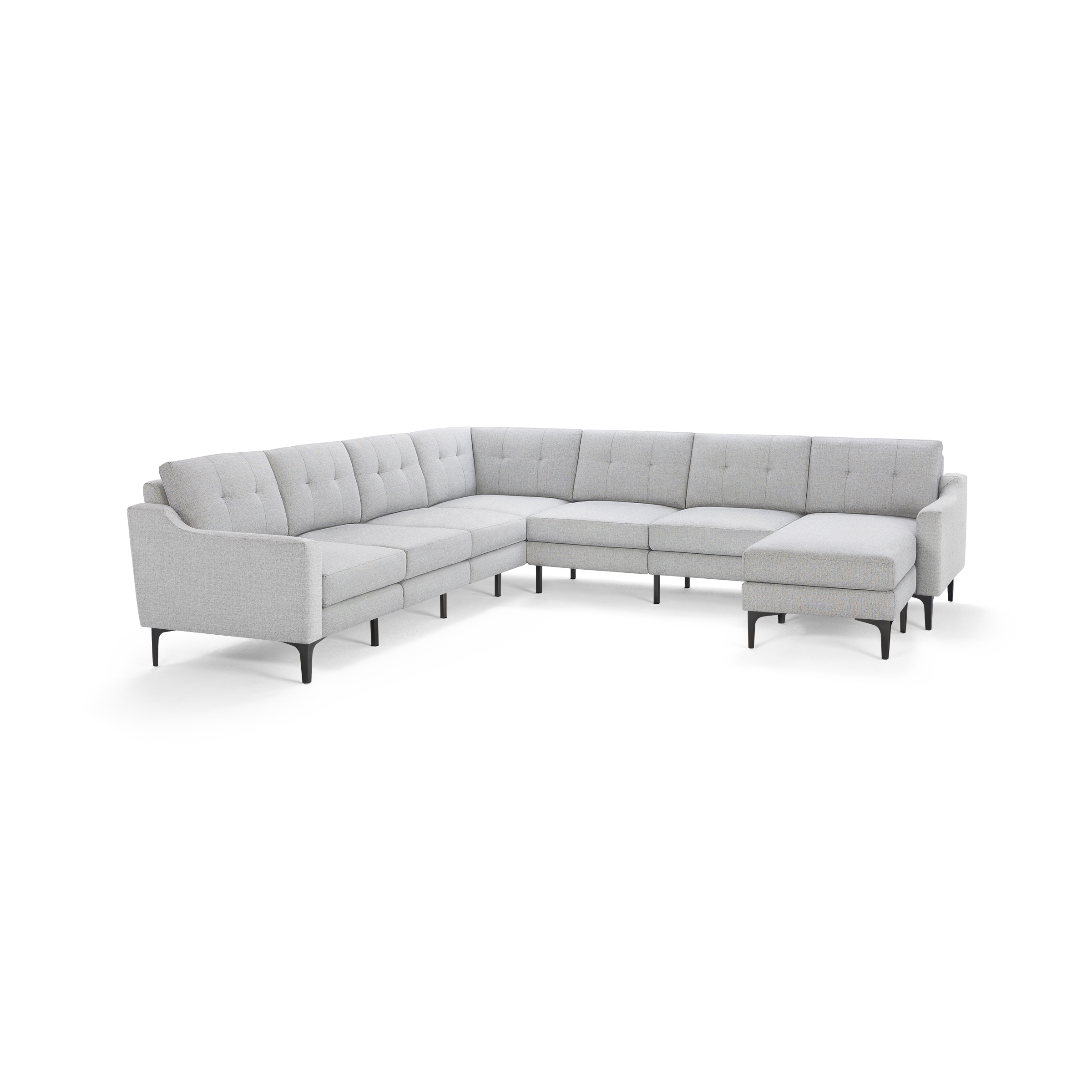 Light gray modern L-shaped sectional sofa with tufted back cushions, slim black legs, and a chaise lounge on the right side.