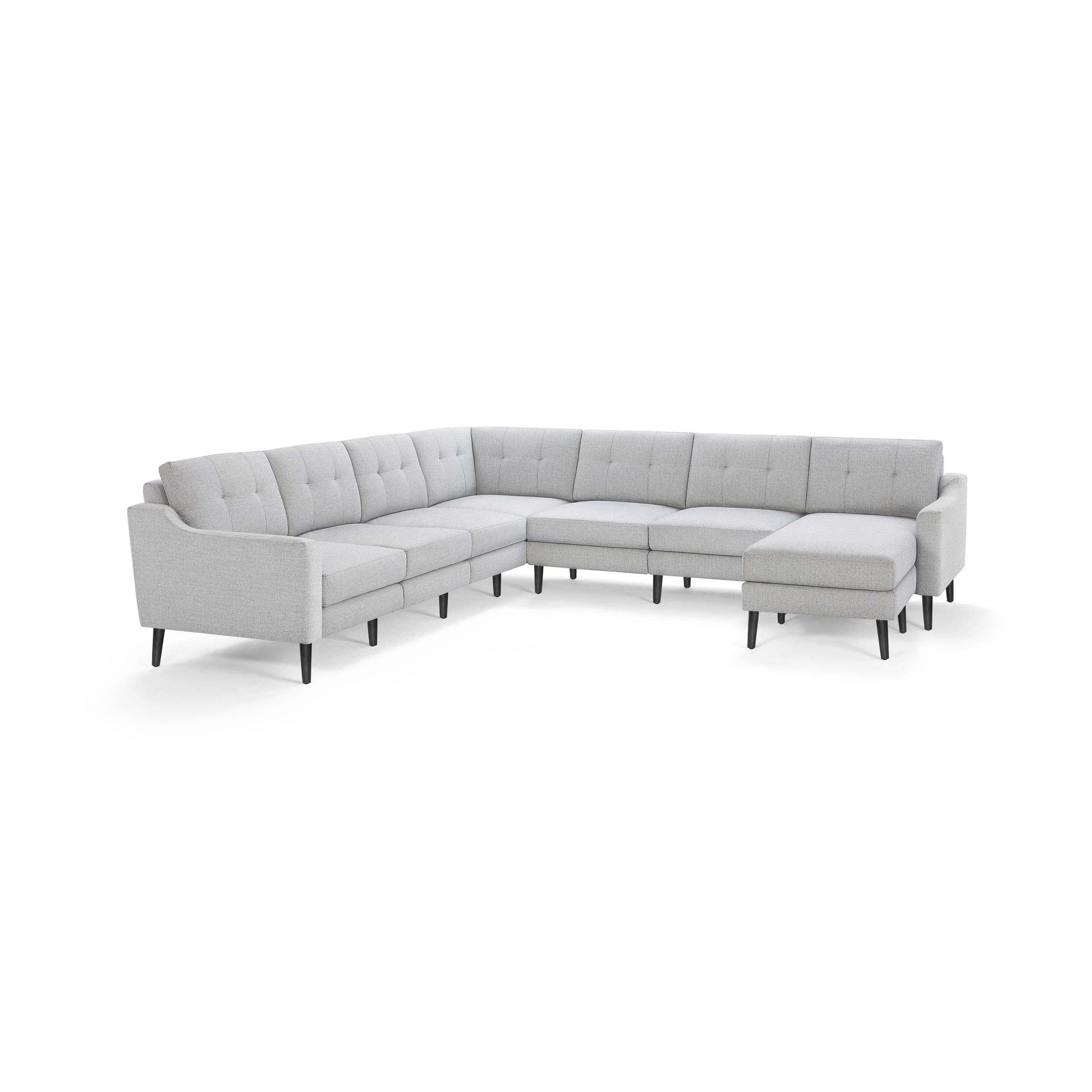 Large light gray fabric sectional sofa with tufted back cushions and slim black wooden legs, arranged in an L-shape.