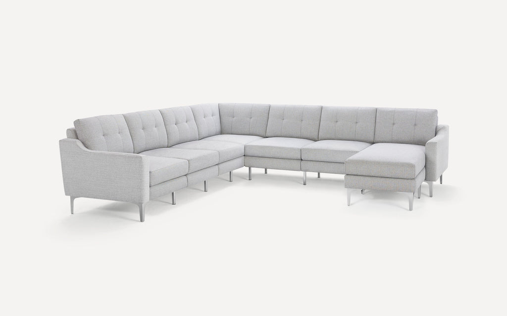 Light gray fabric sectional sofa with modern tufted back cushions, slim angled arms, and metal legs on a white background.
