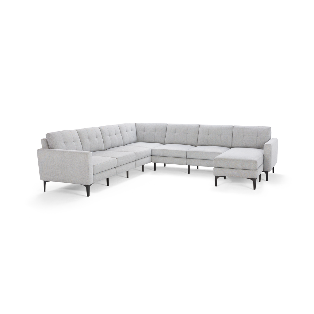 Light gray fabric sectional sofa with tufted cushions and slim black metal legs, featuring a modern L-shaped design.