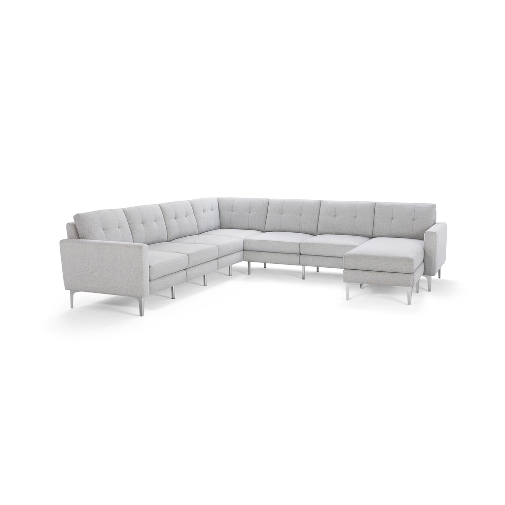 Light gray L-shaped sectional sofa with tufted cushioning, slim armrests, and metal legs, designed for modern living rooms.