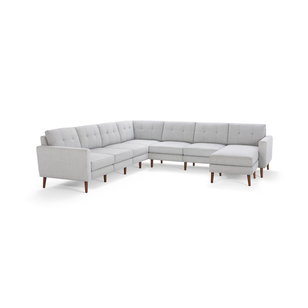 Light gray L-shaped sectional sofa with tufted back cushions, wooden legs, and a modern, minimalist design.