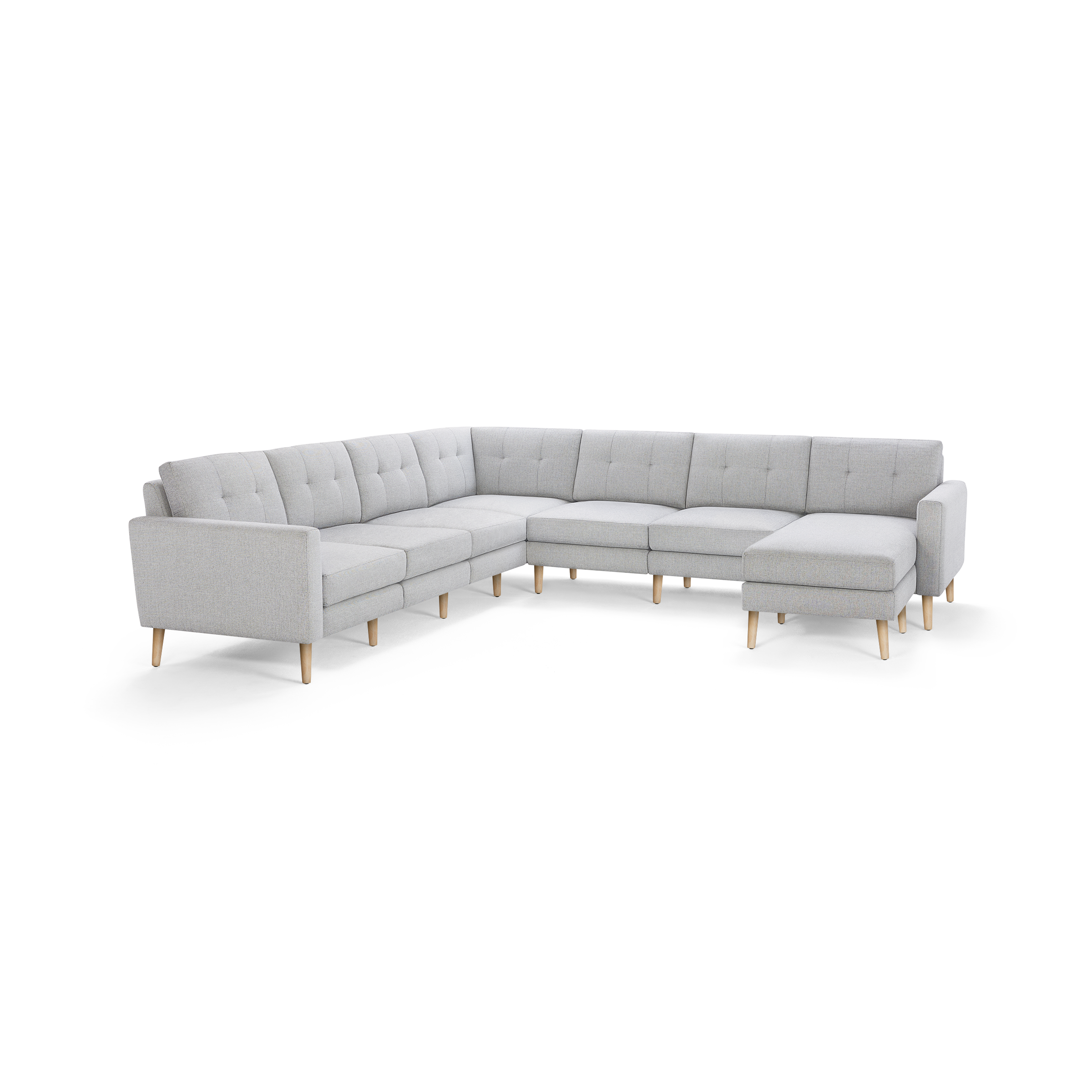 Light gray fabric L-shaped sectional sofa with tufted back cushions and wooden legs, featuring a chaise lounge on the right side.