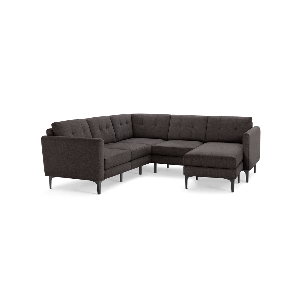 Dark gray L-shaped sectional sofa with tufted cushions, slim metal legs, and modern design suitable for living rooms.