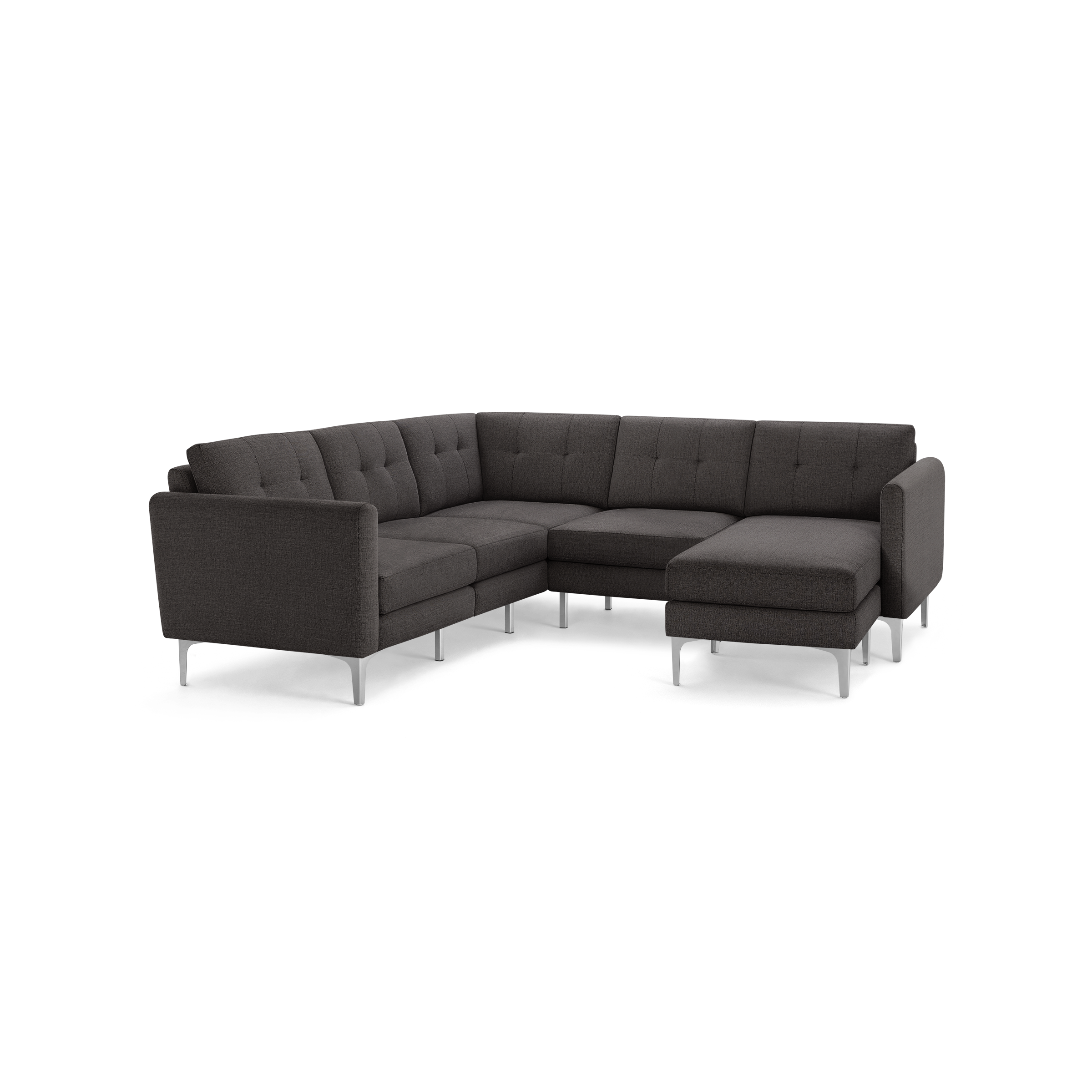 Dark gray fabric sectional sofa with tufted back cushions, angled arms, and sleek silver metal legs on a black background.