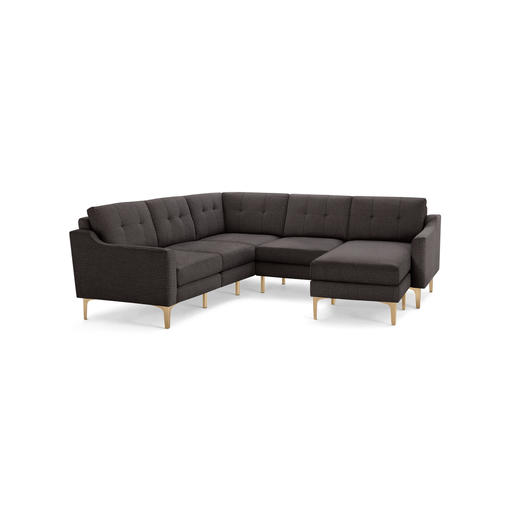 Dark gray fabric sectional sofa with tufted cushions, modern gold metal legs, and an L-shaped design featuring a chaise lounge.
