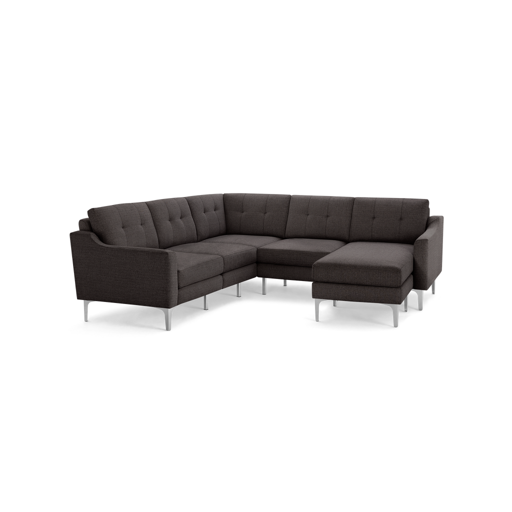 Modern dark gray fabric L-shaped sectional sofa with tufted back cushions and sleek metal legs.