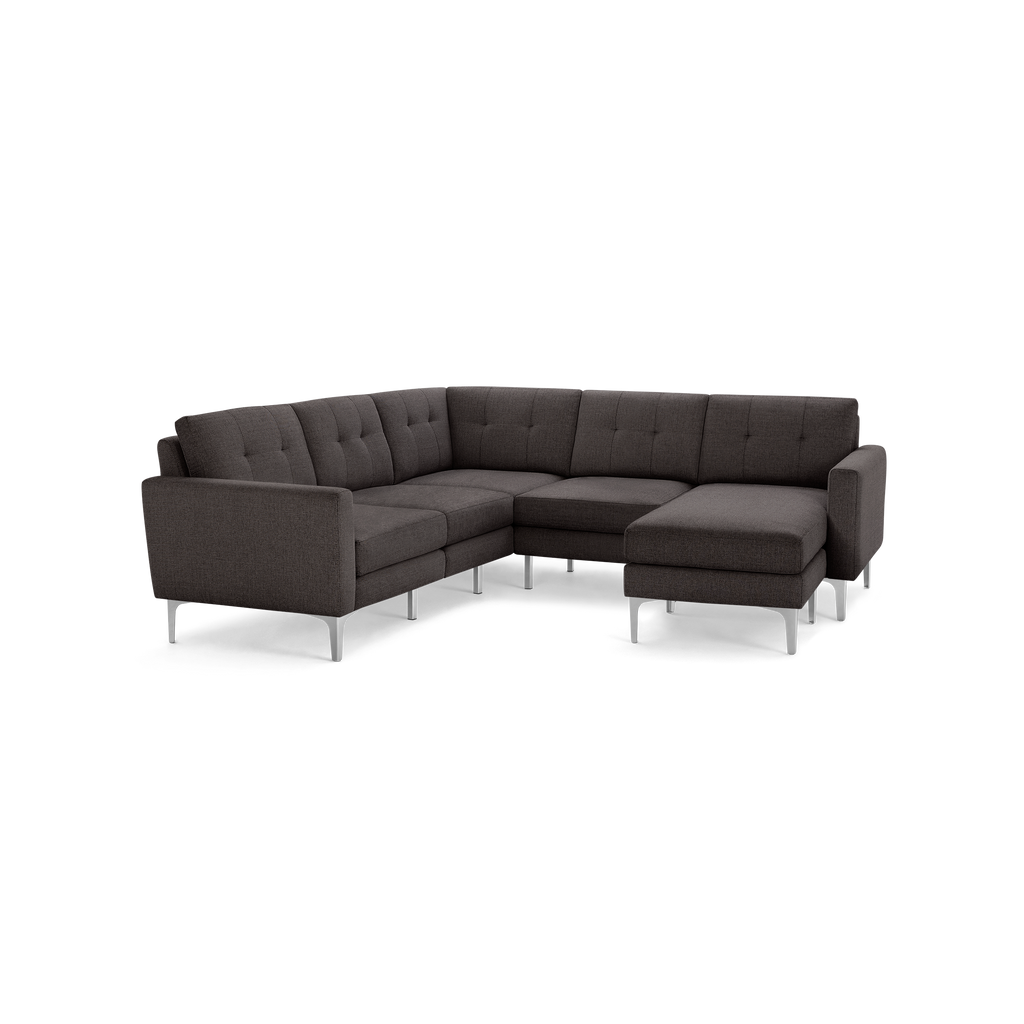 Dark gray fabric L-shaped sectional sofa with tufted back cushions and sleek silver metal legs.