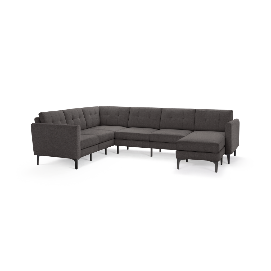 Modern dark gray fabric sectional sofa with tufted cushions, metal legs, and an L-shaped design featuring a chaise lounge on the right side.