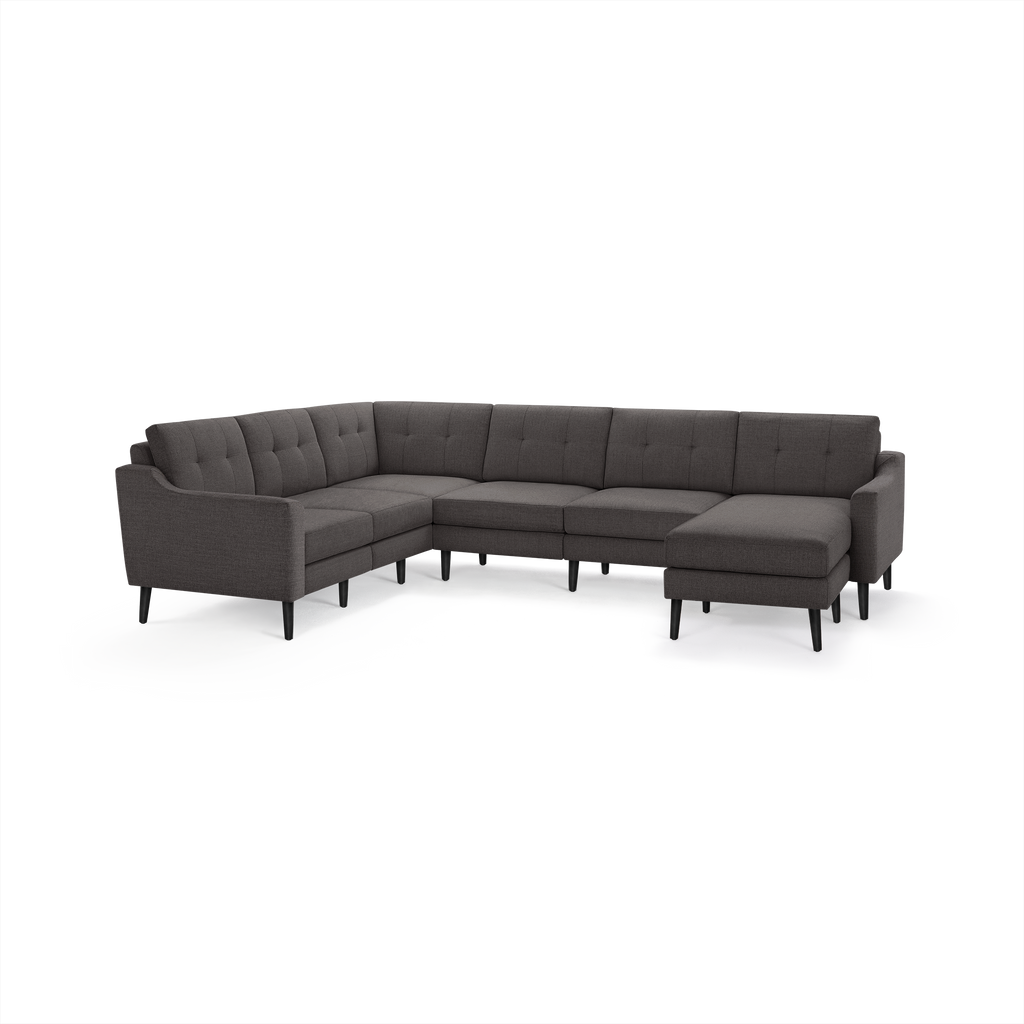 Gray fabric upholstered modern sectional sofa with tufted back cushions and black tapered wooden legs.
