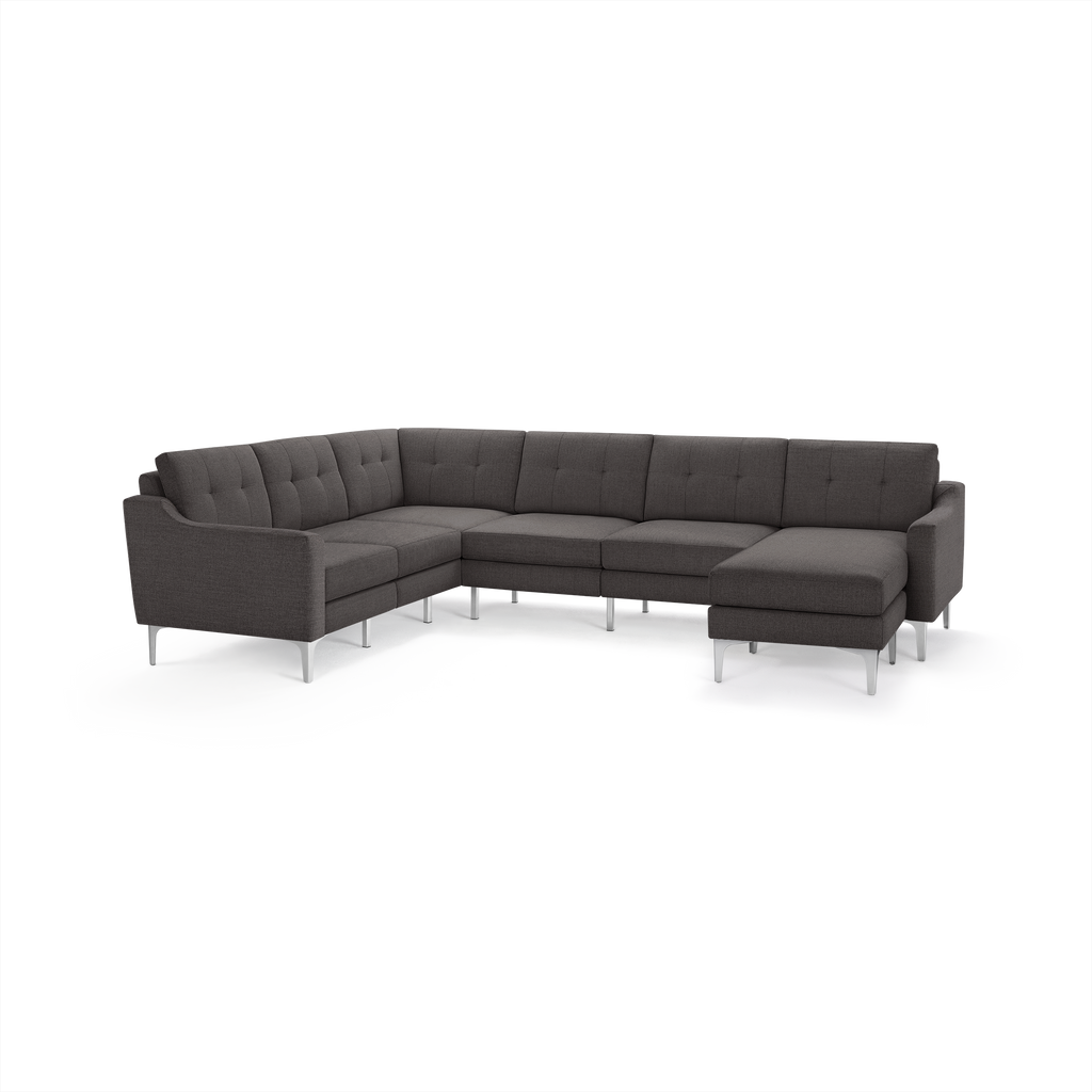 Modern dark gray fabric sectional sofa with tufted back cushions and sleek metal legs, designed for corner placement.