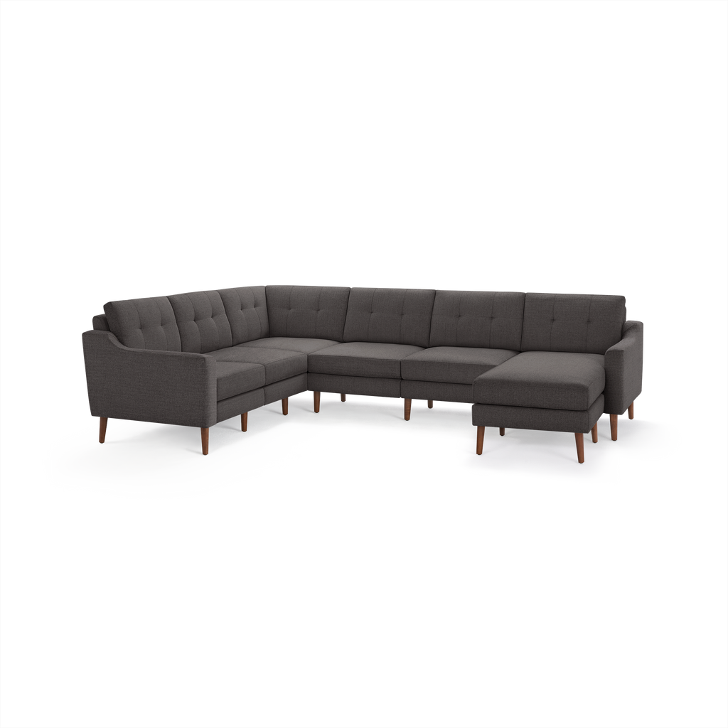 Modern dark gray fabric sectional sofa with tufted back cushions, wooden legs, and right-side chaise lounge.
