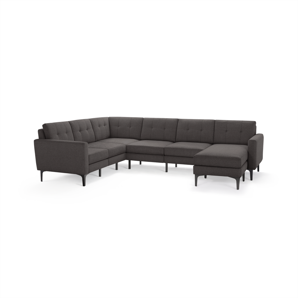 Gray fabric sectional sofa with tufted backrests, modern slim black legs, and a right-side chaise lounge.