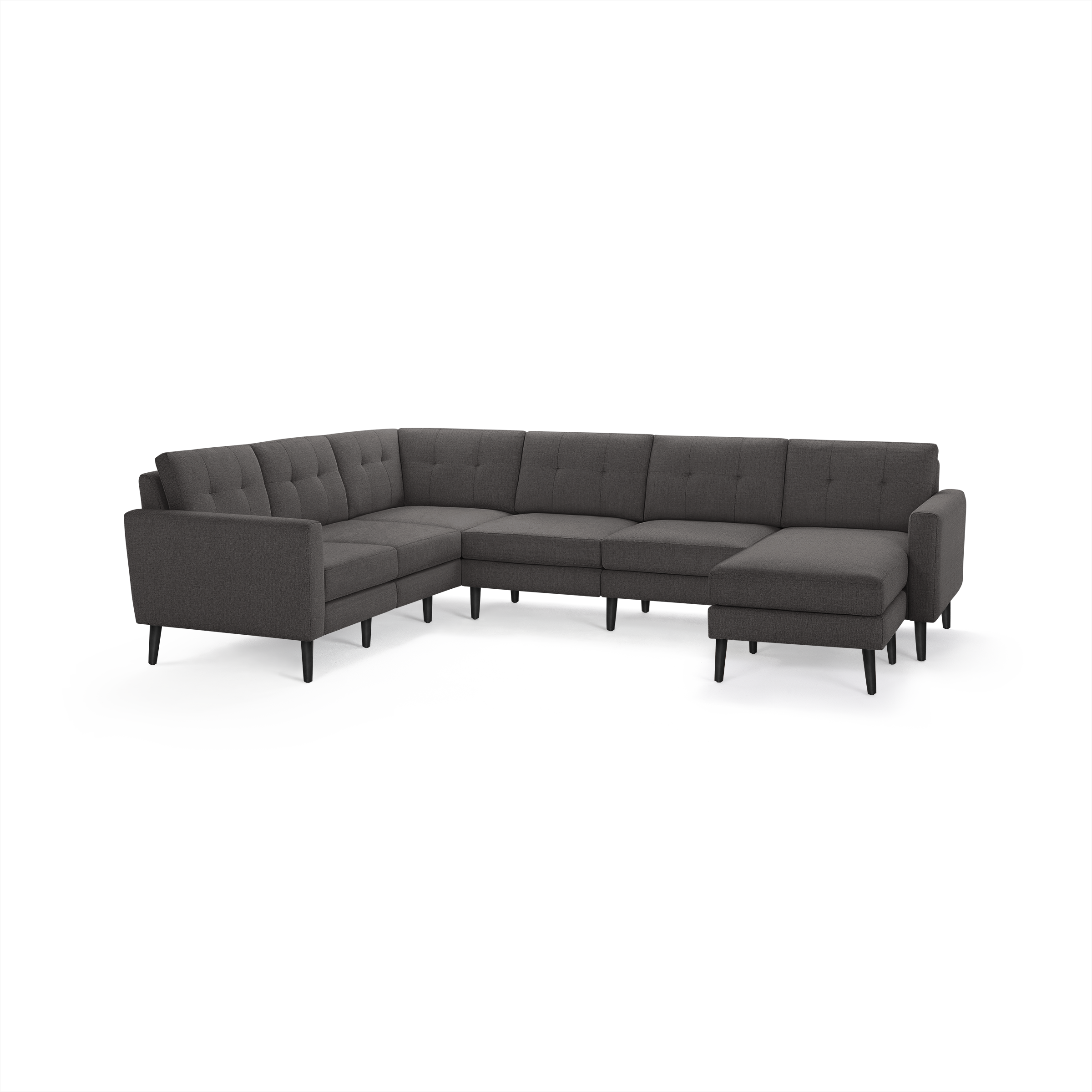 Dark gray modern sectional sofa with tufted back cushions, sleek slightly angled arms, and black tapered legs.