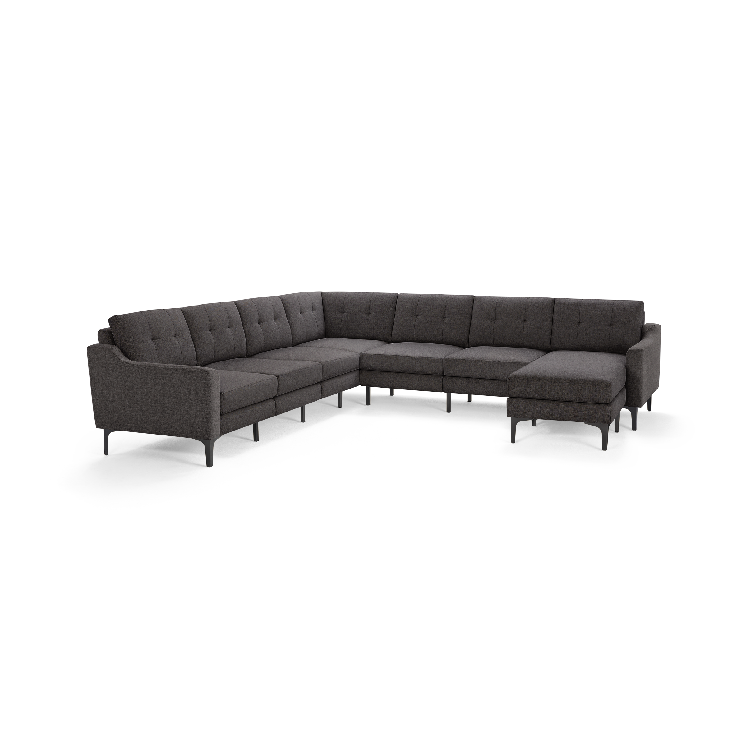 Large dark gray upholstered sectional sofa with tufted back cushions and slim black legs, designed for corner placement.
