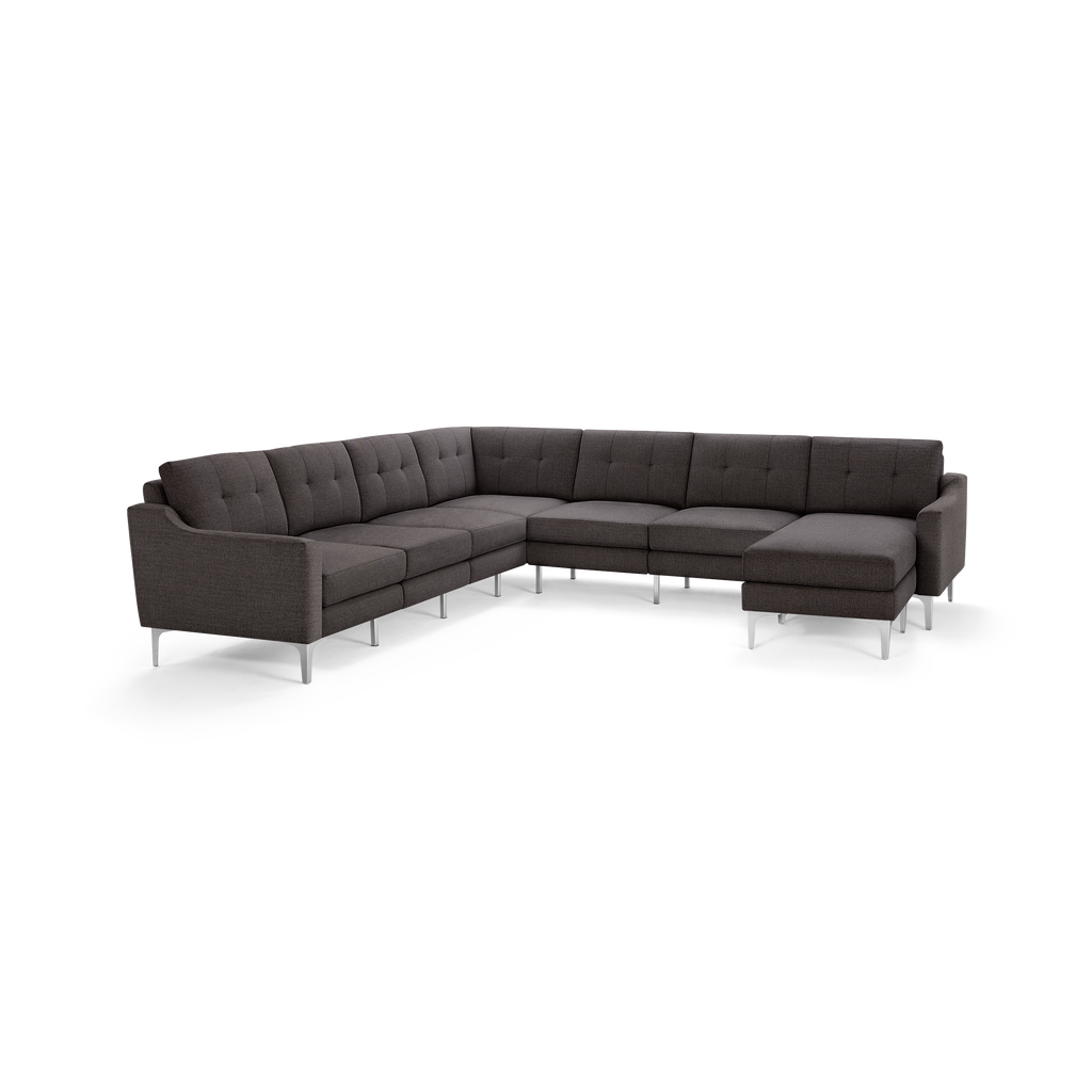 Dark gray modern L-shaped sectional sofa with tufted back cushions and slim metal legs, designed for spacious living rooms.