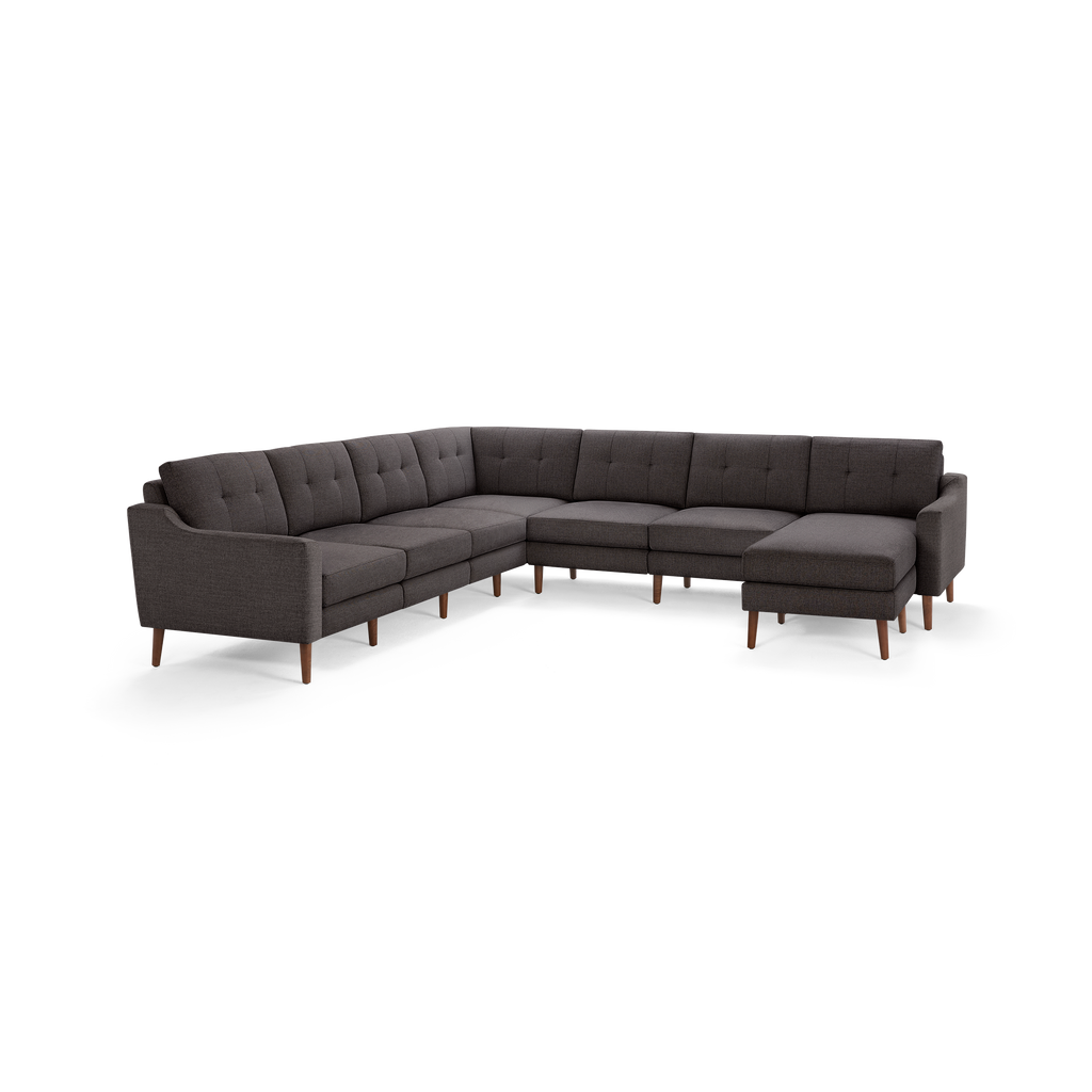 Large L-shaped sectional sofa with tufted dark gray fabric upholstery, wooden legs, and a right-side chaise lounge.