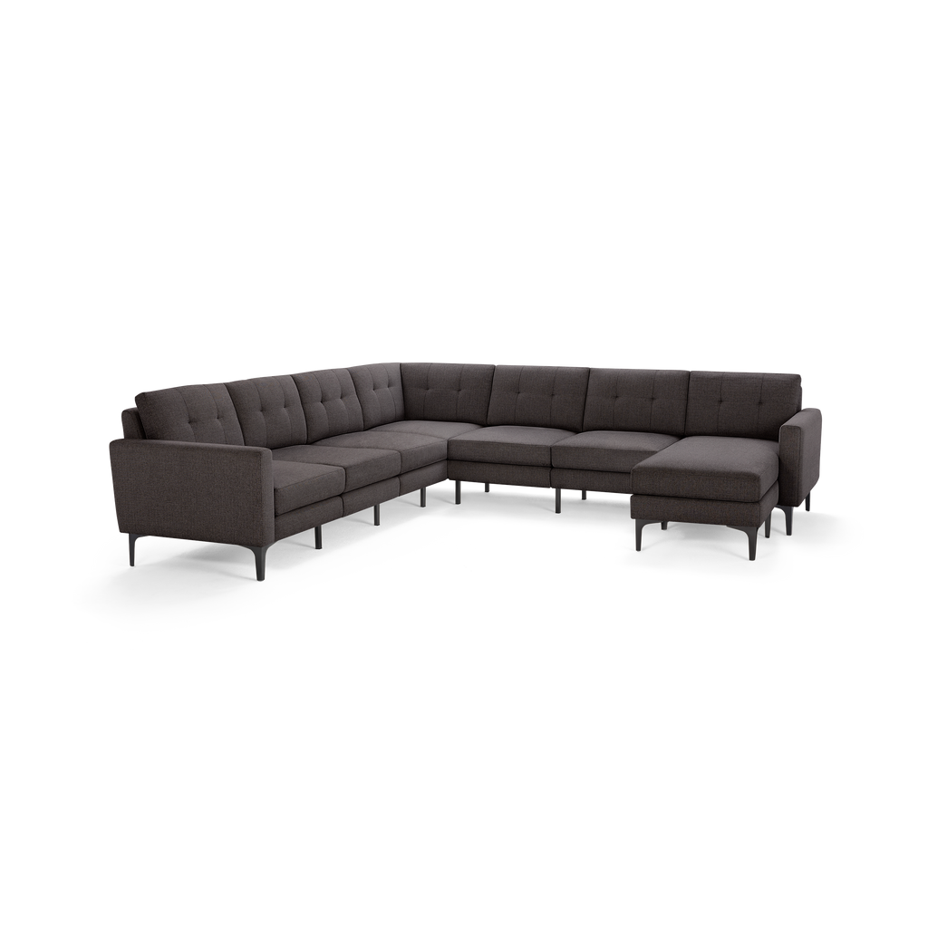 Large modern dark gray fabric sectional sofa with tufted back cushions and sleek metal legs, arranged in an L-shape.