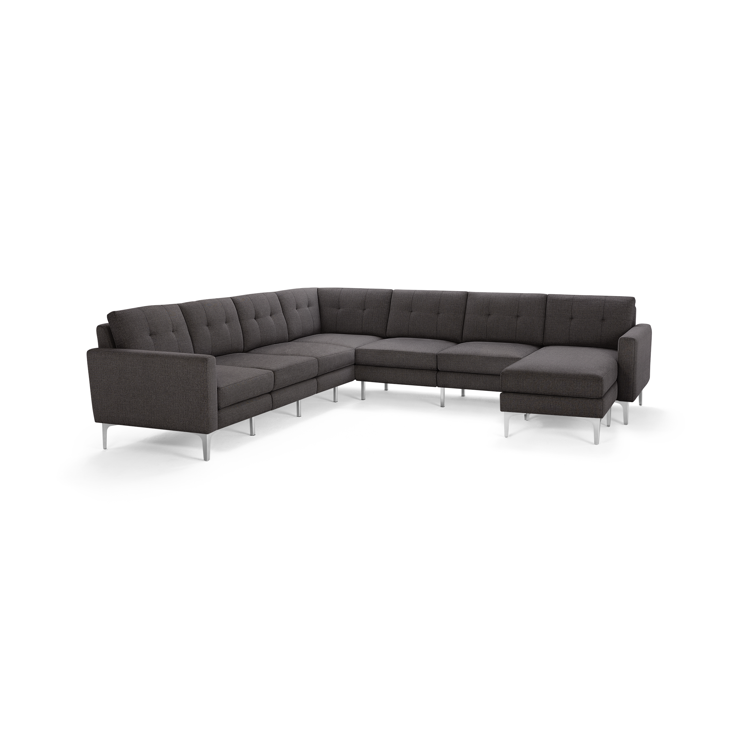 Dark gray L-shaped sectional sofa with tufted cushions and slim metal legs, featuring a chaise lounge on the right side.