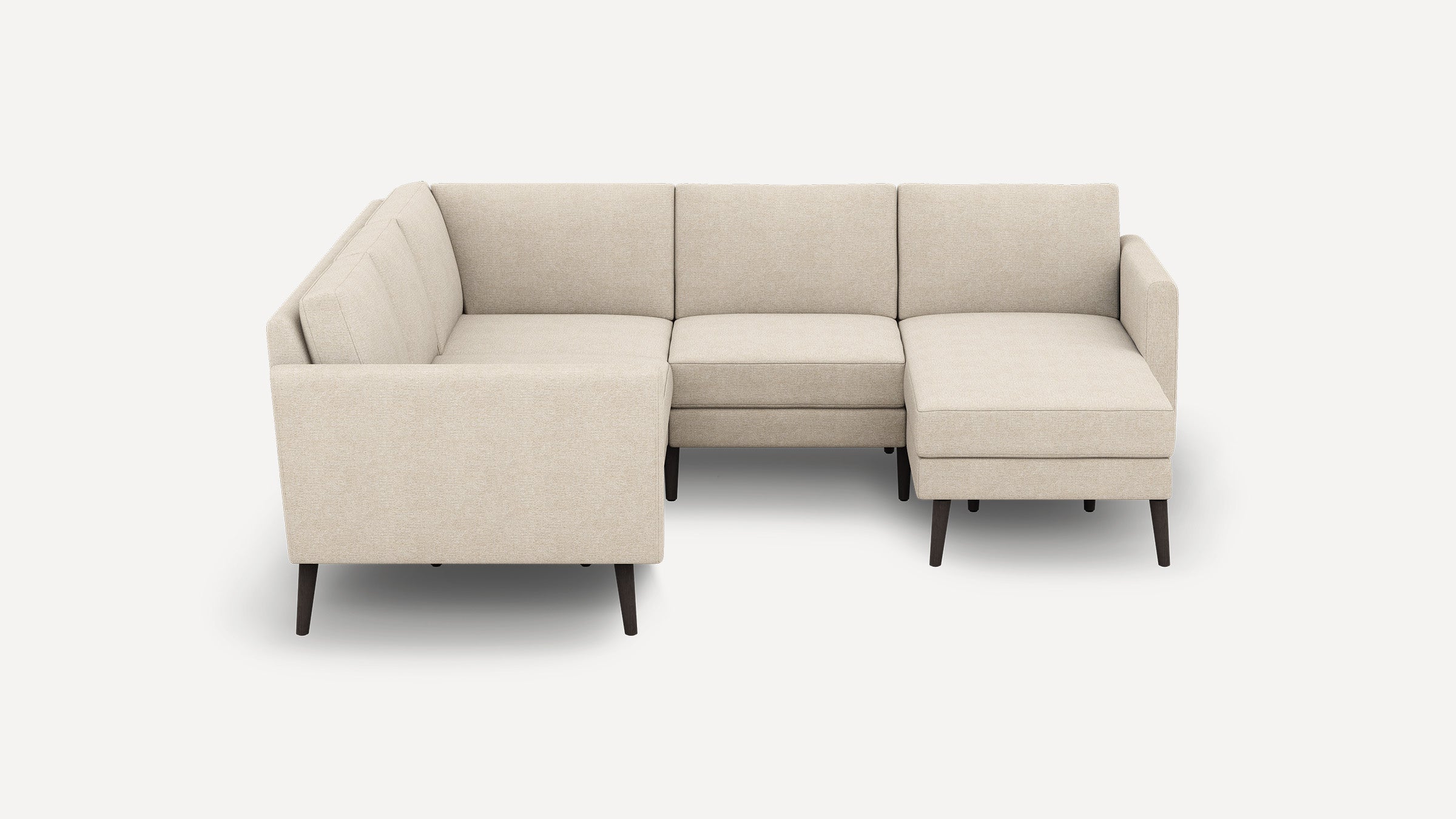 Beige upholstered L-shaped sectional sofa with clean lines, tufted cushions, and dark tapered wooden legs on white background.