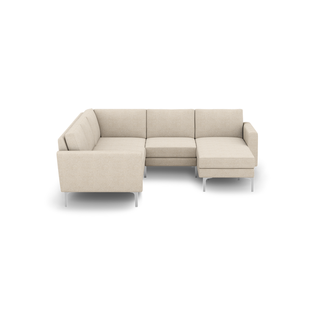 Beige L-shaped sectional sofa with metal legs, featuring three seat cushions and a corner design, shown against a black background.