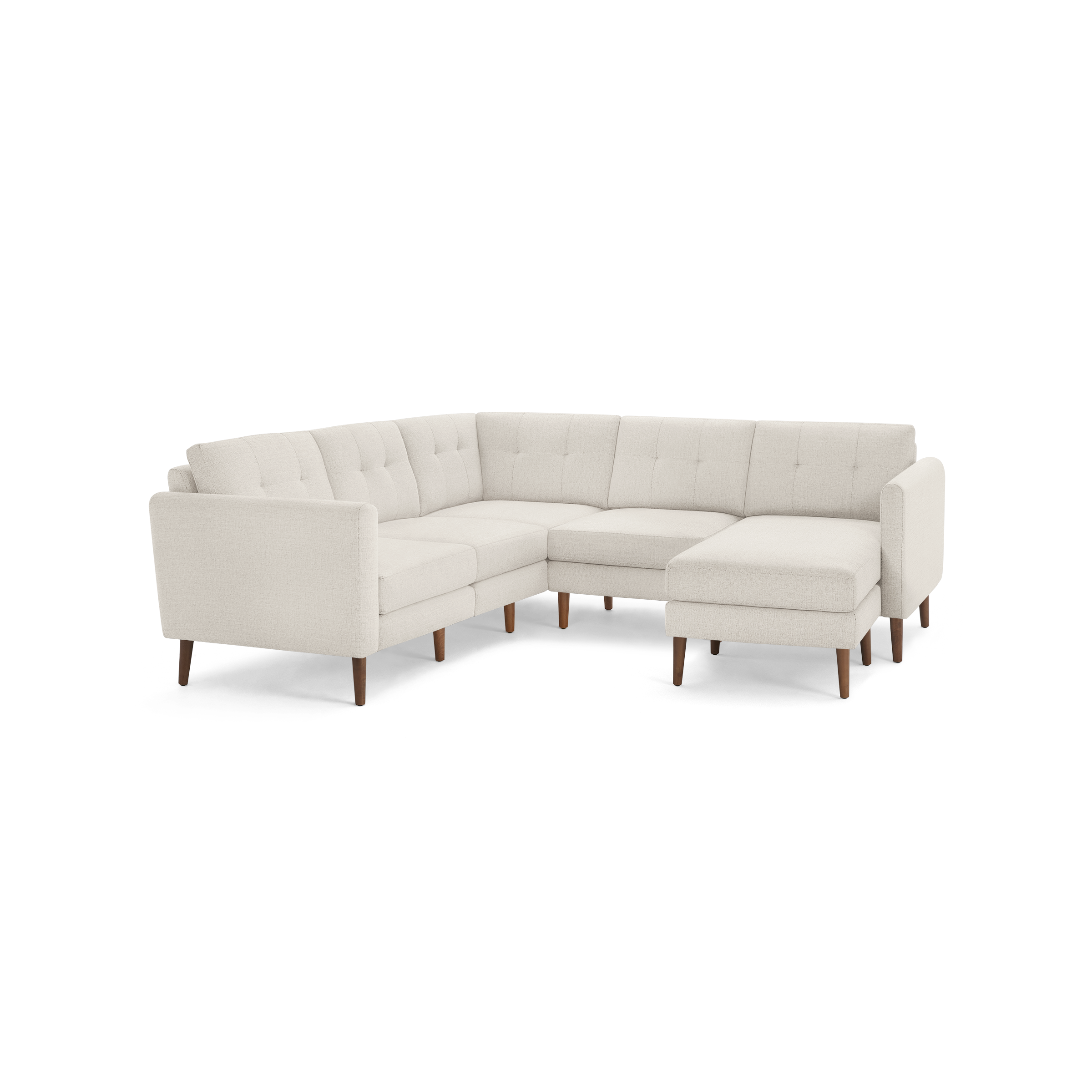 L-shaped beige fabric sectional sofa with tufted back cushions and wooden legs, featuring a chaise lounge on the right side.
