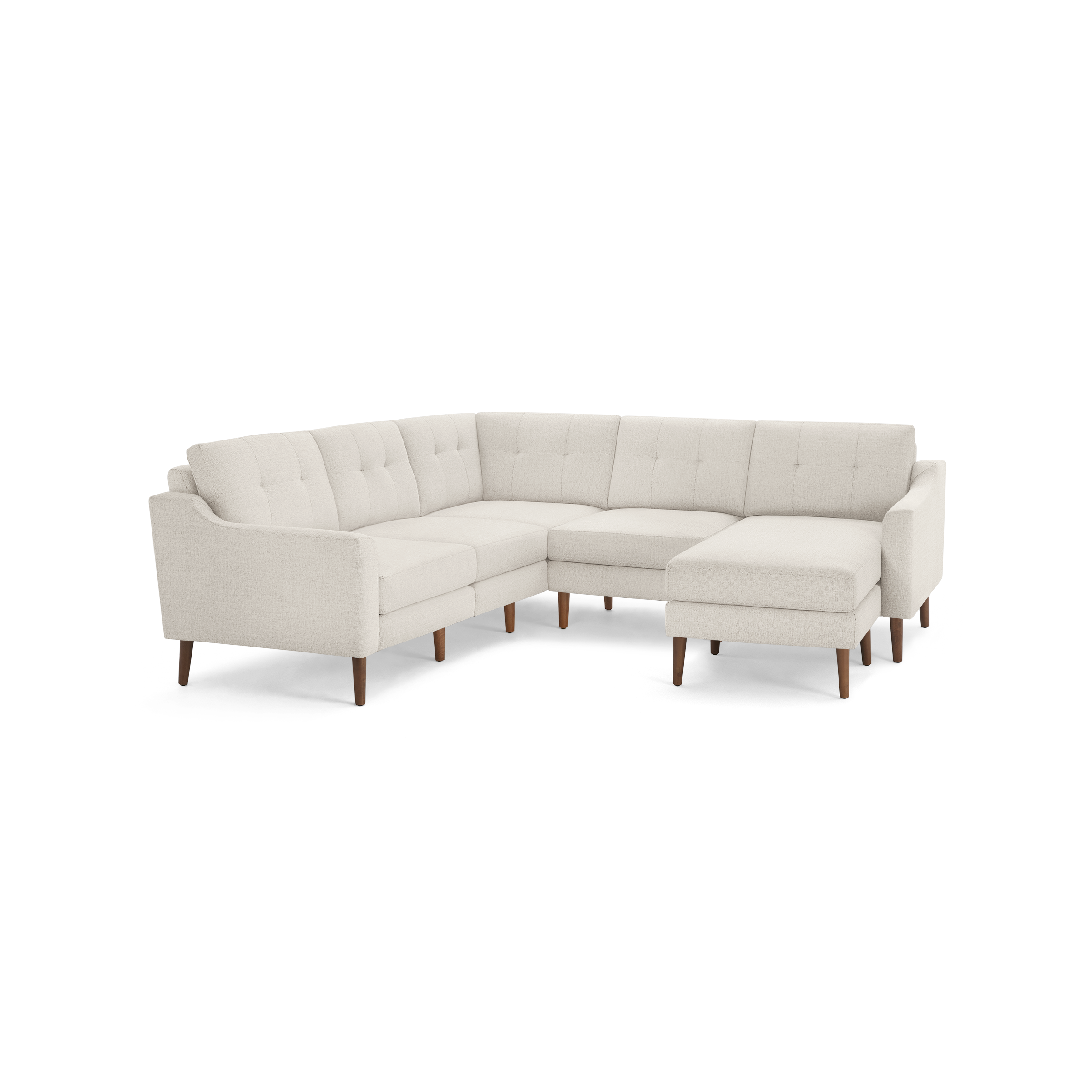 Light beige fabric sectional sofa with tufted back cushions, wooden legs, and an L-shaped design featuring a chaise lounge on the right side.