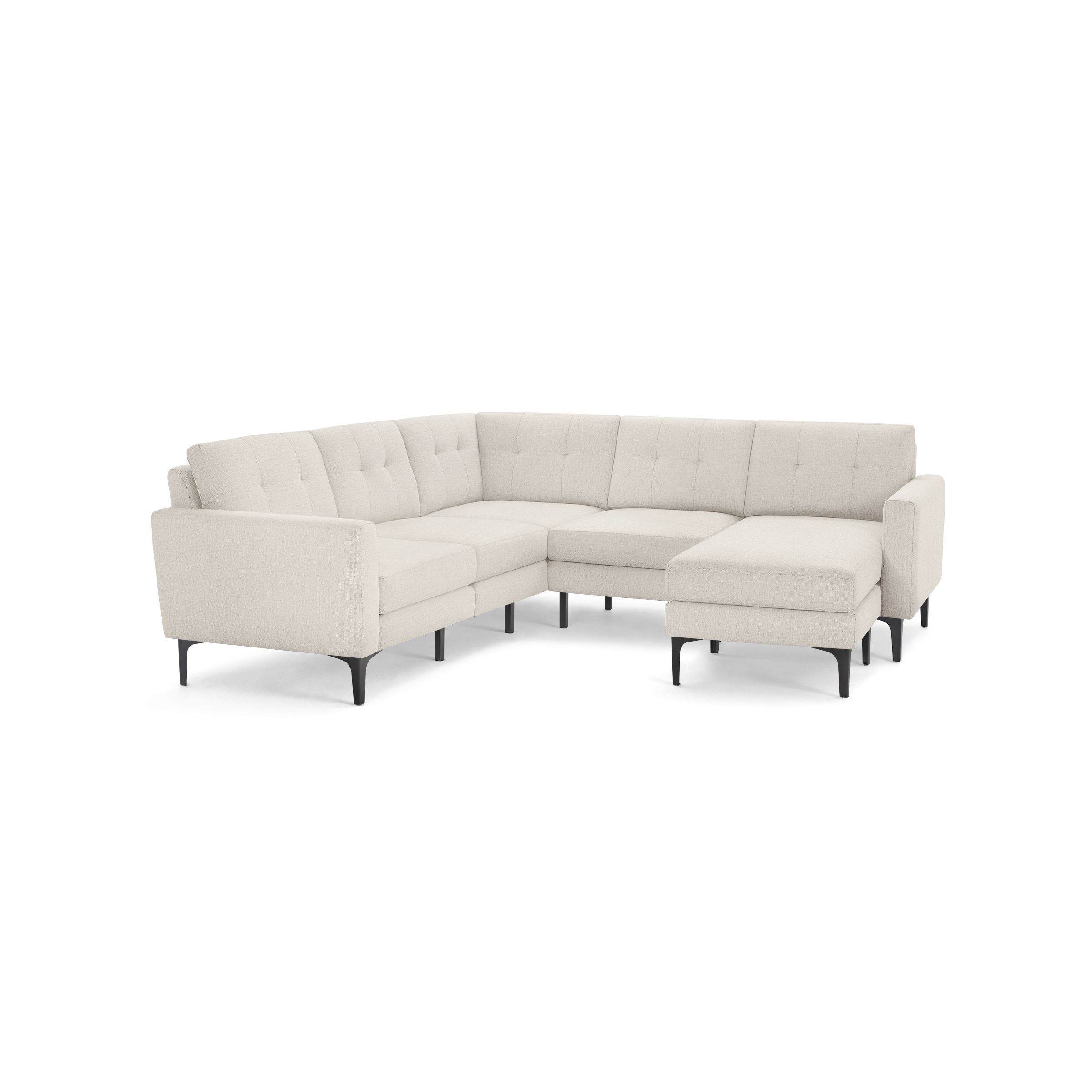 Light beige fabric L-shaped sectional sofa with tufted cushions and black angled legs on a black background.