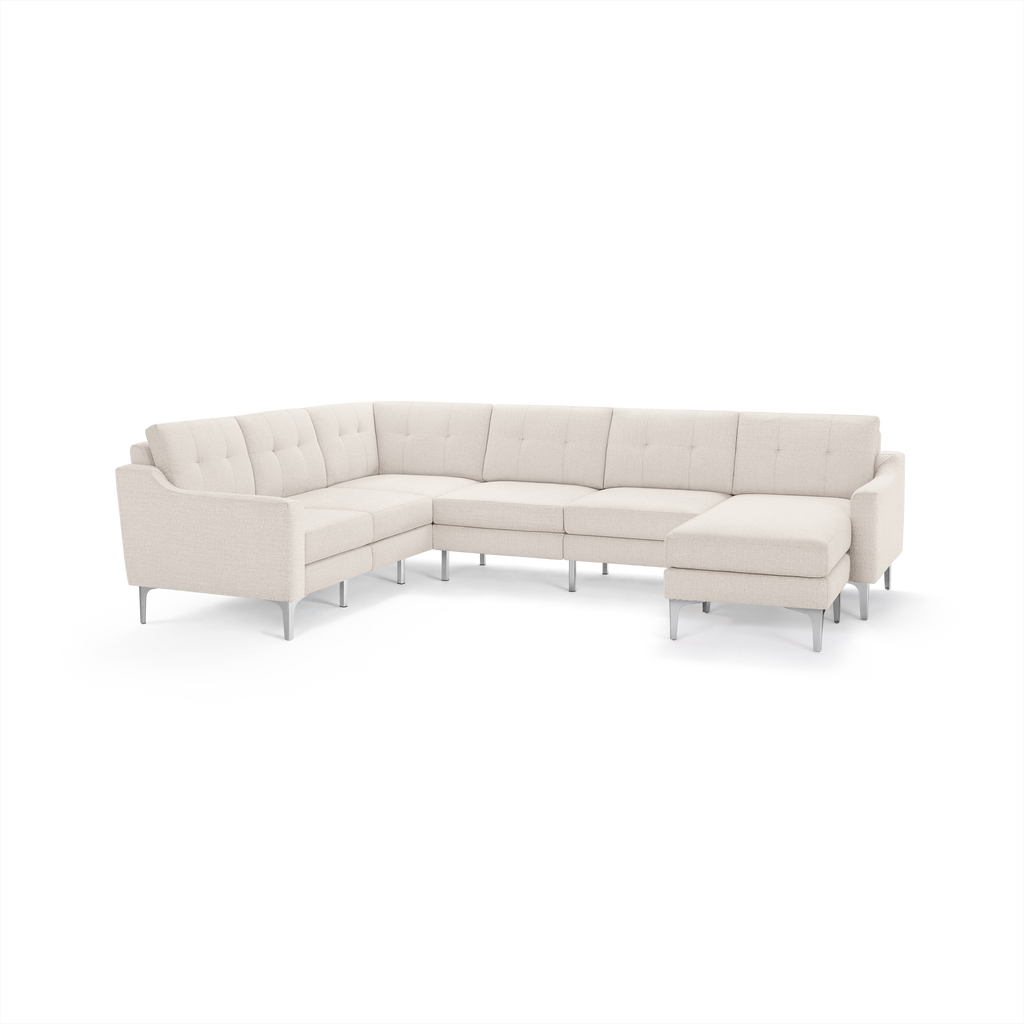 Cream-colored modern sectional sofa with tufted cushions, clean lines, and metal legs, designed for spacious corner seating.