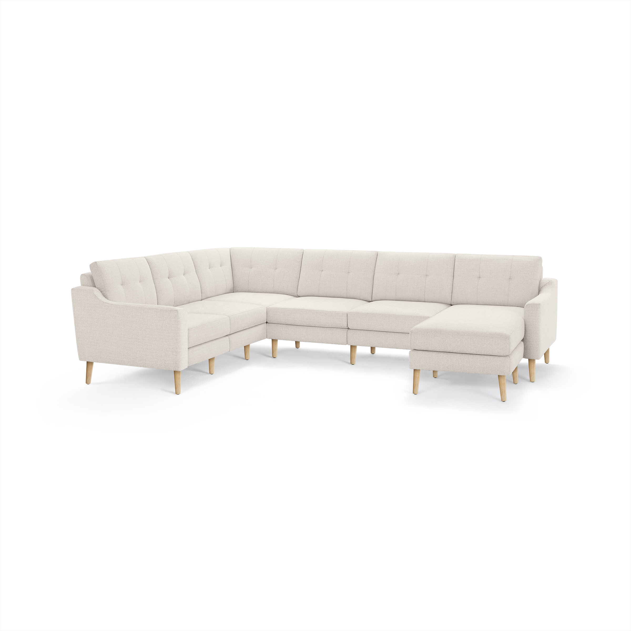 Cream-colored L-shaped sectional sofa with tufted back cushions and wooden tapered legs, featuring a right-side chaise lounge.