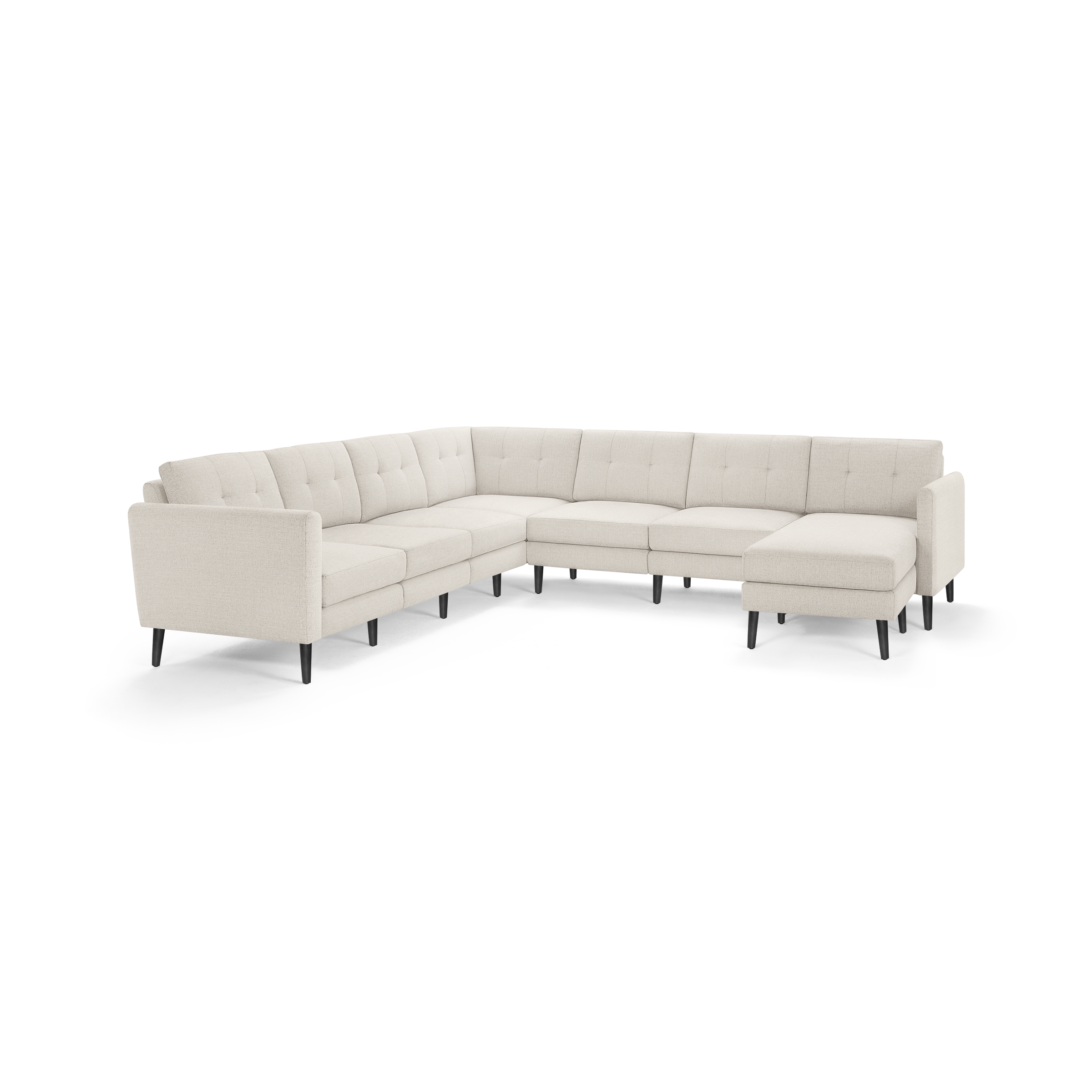 Large L-shaped sectional sofa with beige upholstery, tufted back cushions, straight arms, and black tapered legs.