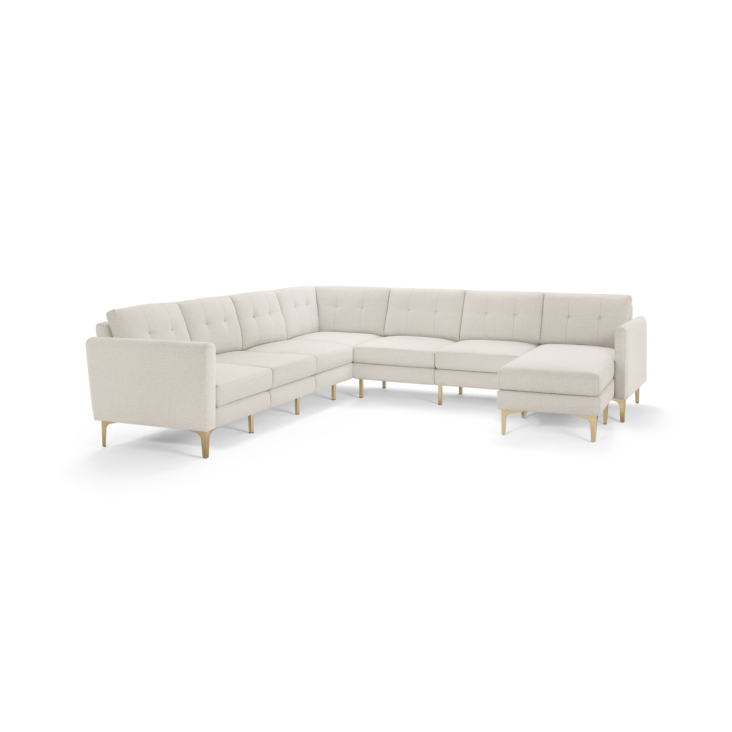 Large L-shaped sectional sofa with tufted beige fabric upholstery and light wooden legs, featuring a chaise lounge on the right side.