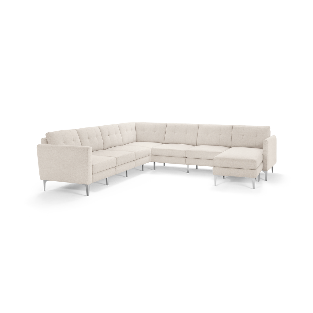 Beige L-shaped sectional sofa with tufted cushions and metal legs, featuring a chaise lounge on the right side.
