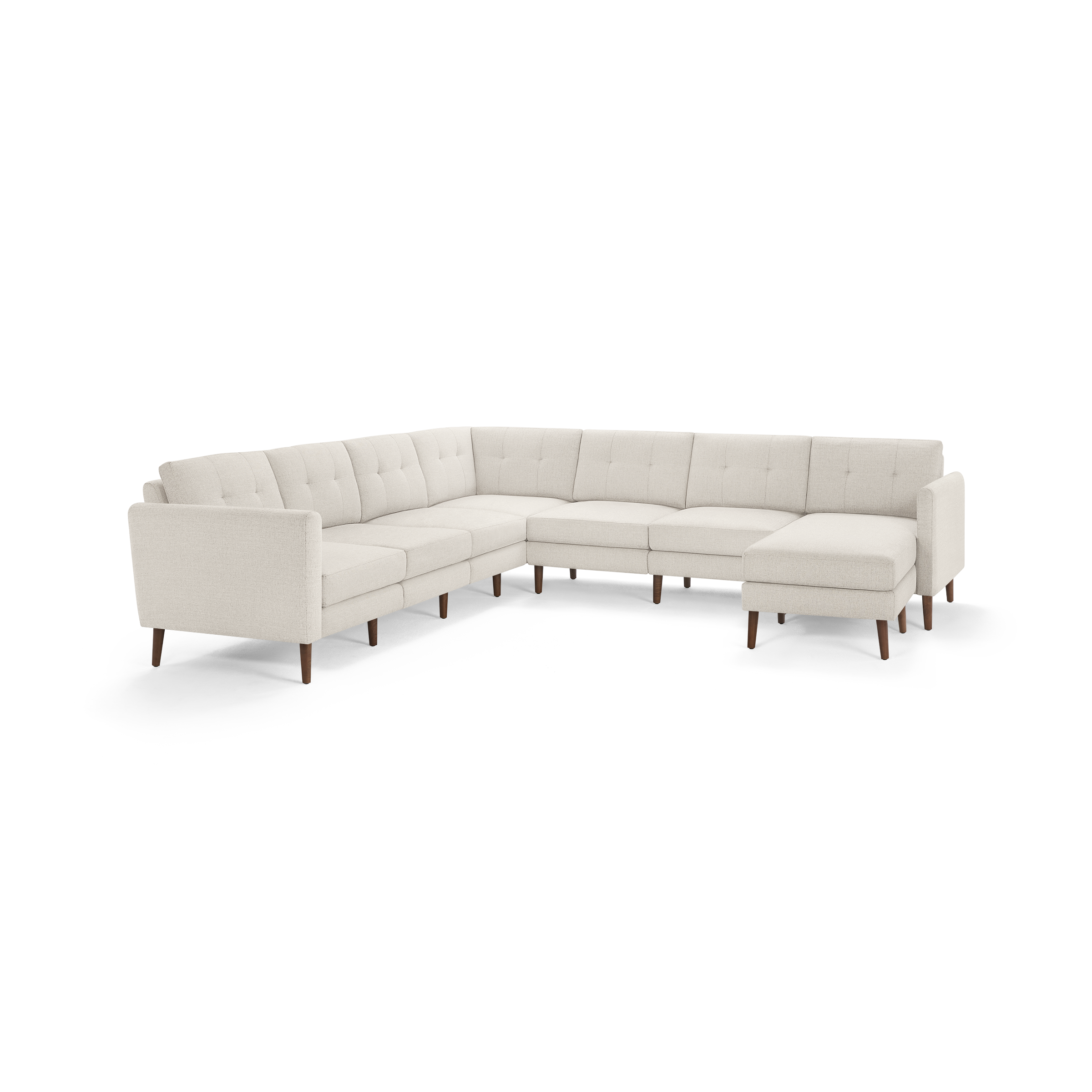 Light beige fabric sectional sofa with tufted cushions, wooden legs, and an L-shaped design featuring a chaise lounge on the right side.