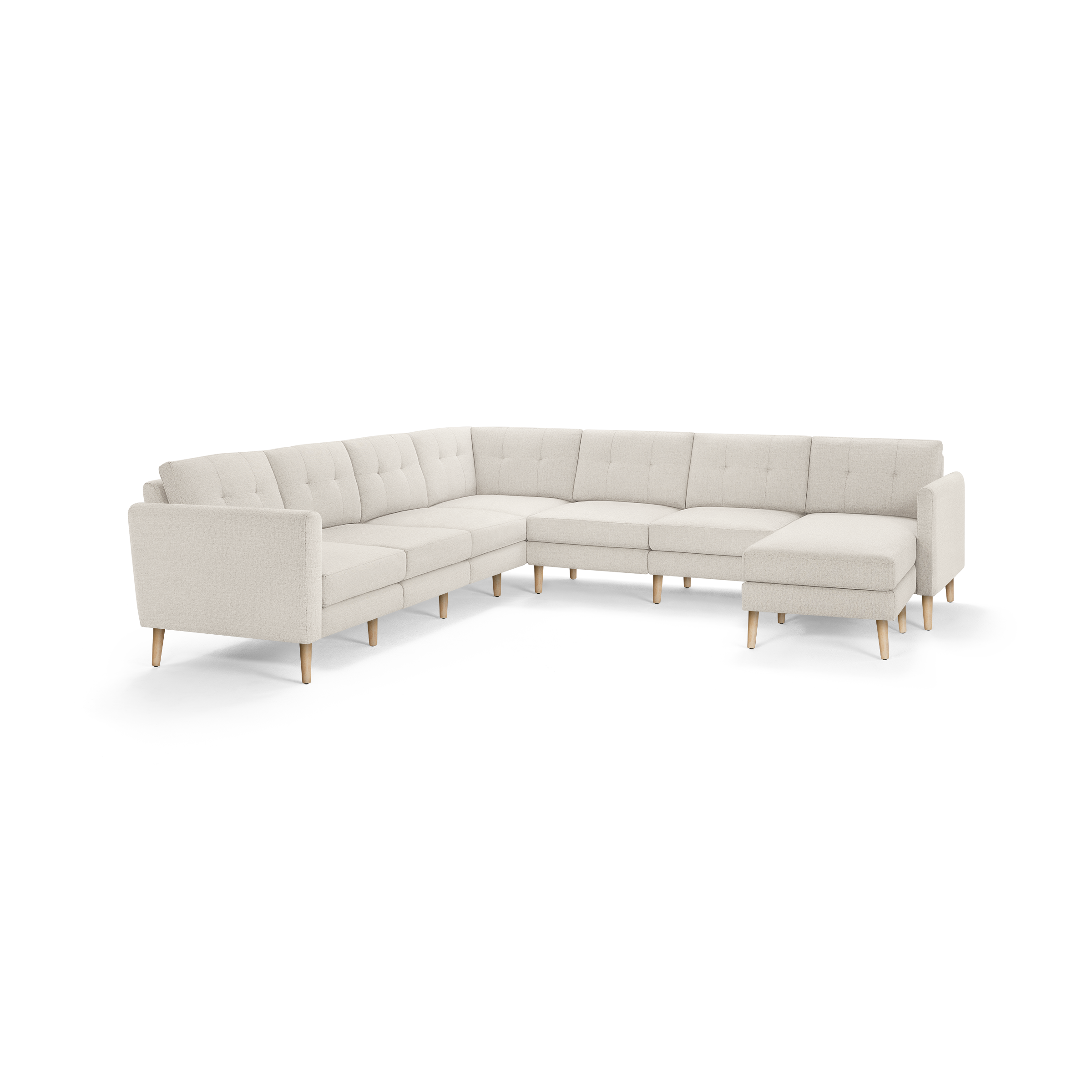 Large L-shaped sectional sofa with beige tufted cushions and light wooden legs, designed for spacious living rooms.