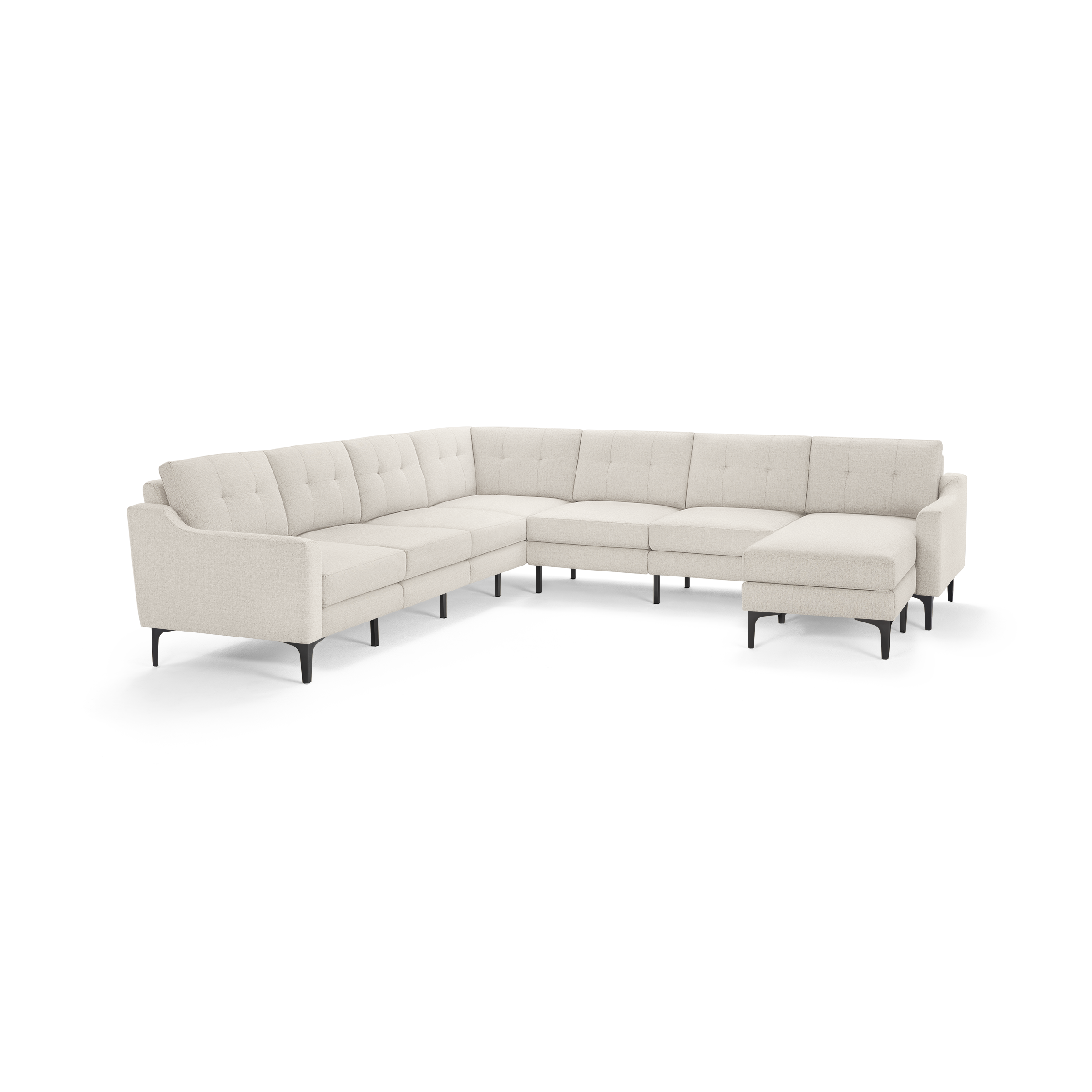 Large L-shaped beige sectional sofa with tufted back cushions and black slender legs, designed for spacious living rooms.