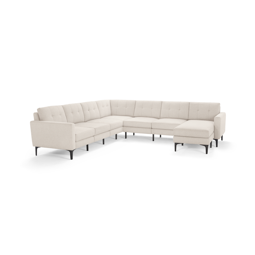 Modern beige L-shaped sectional sofa with tufted cushions and slim black metal legs, offering ample seating and a chaise lounge.