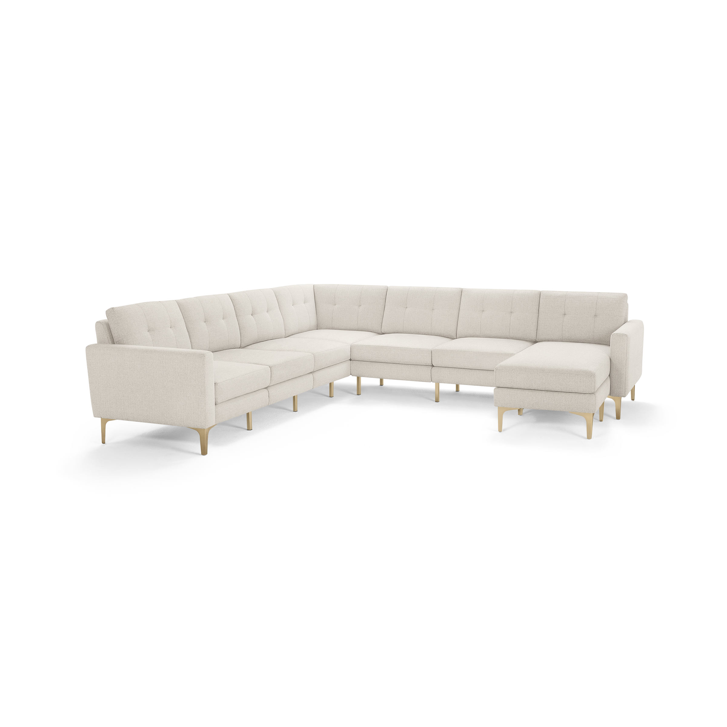 Large L-shaped sectional sofa with beige tufted fabric upholstery and light wooden legs, featuring a chaise lounge on the right side.