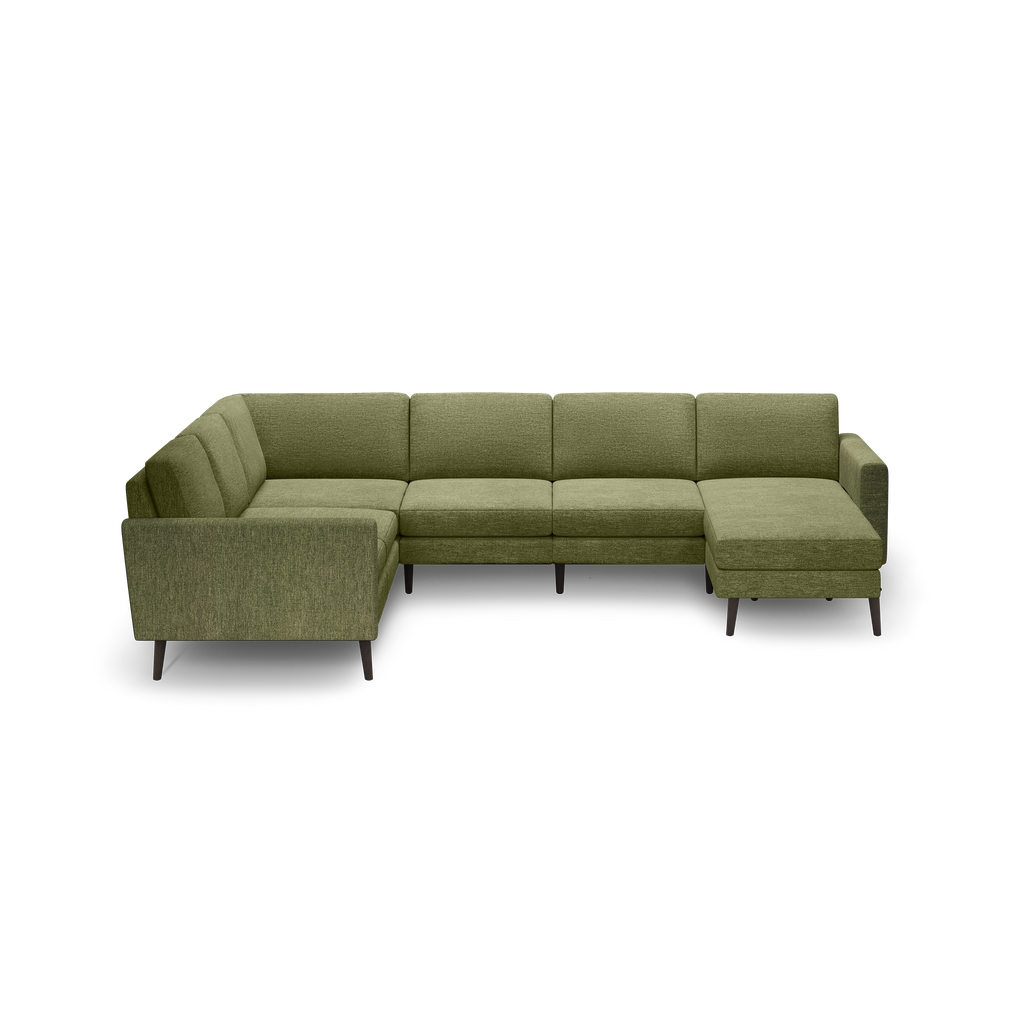 L-shaped sectional sofa with olive-green fabric upholstery and dark wooden legs on a black background.