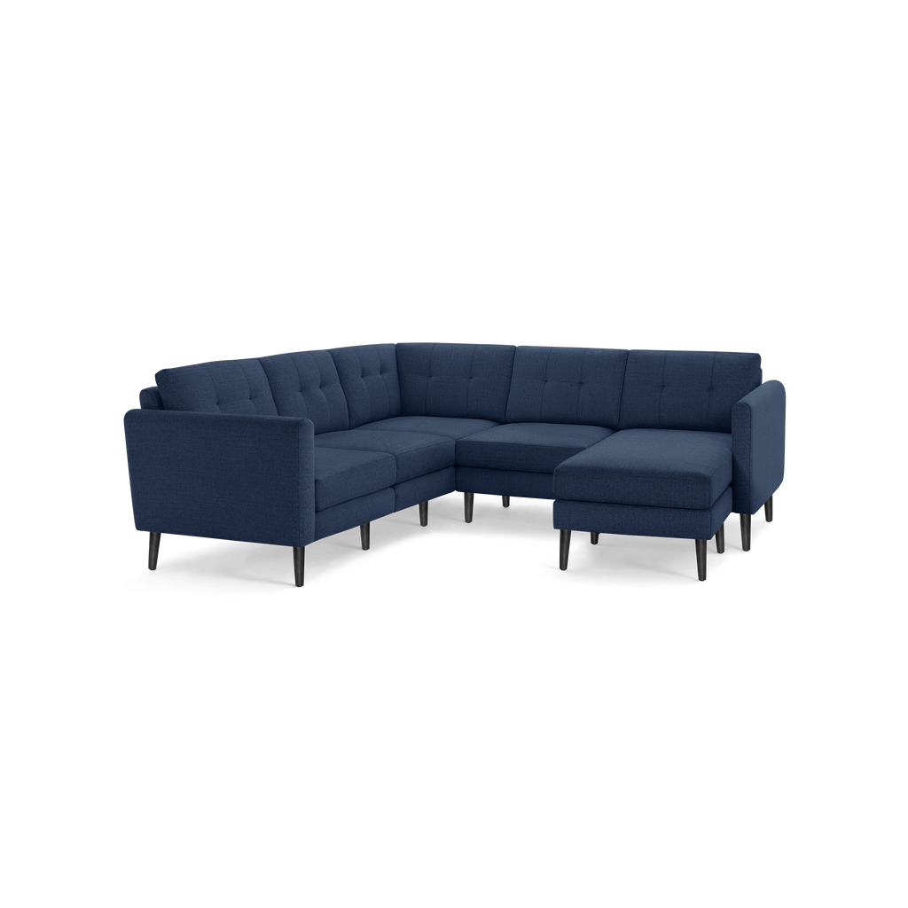 Modern L-shaped navy blue fabric sectional sofa with tufted cushions and black tapered legs, designed for spacious living room comfort.