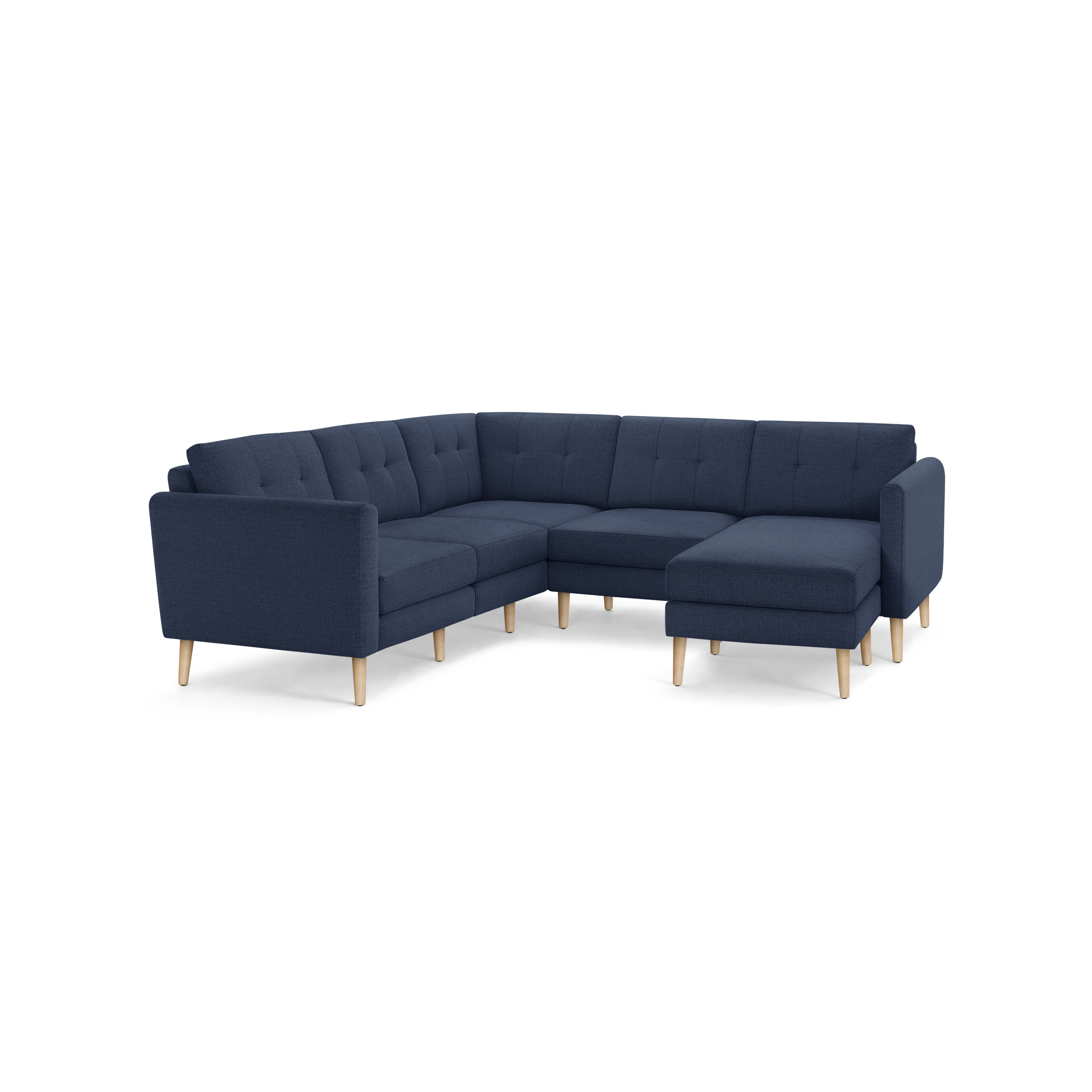 Modern L-shaped sectional sofa in navy blue fabric with tufted back cushions and light wooden legs.