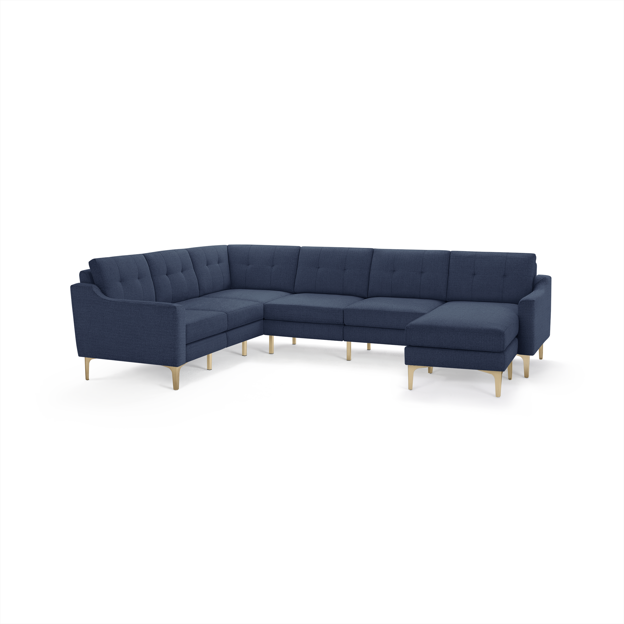 Large L-shaped sectional sofa in navy blue fabric with tufted back cushions and light wooden legs.