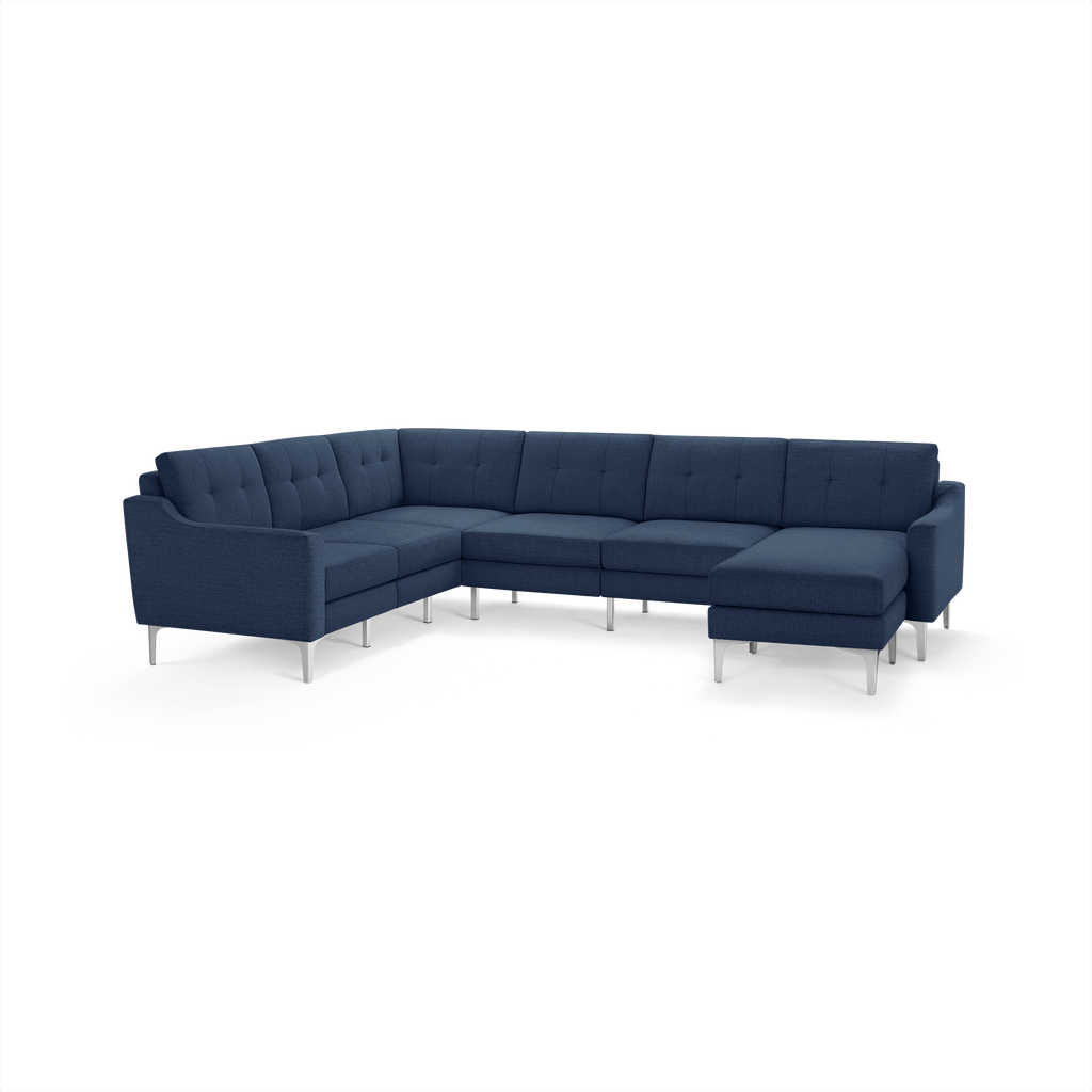 Modern navy blue L-shaped sectional sofa with tufted cushions, slim armrests, and silver metal legs.