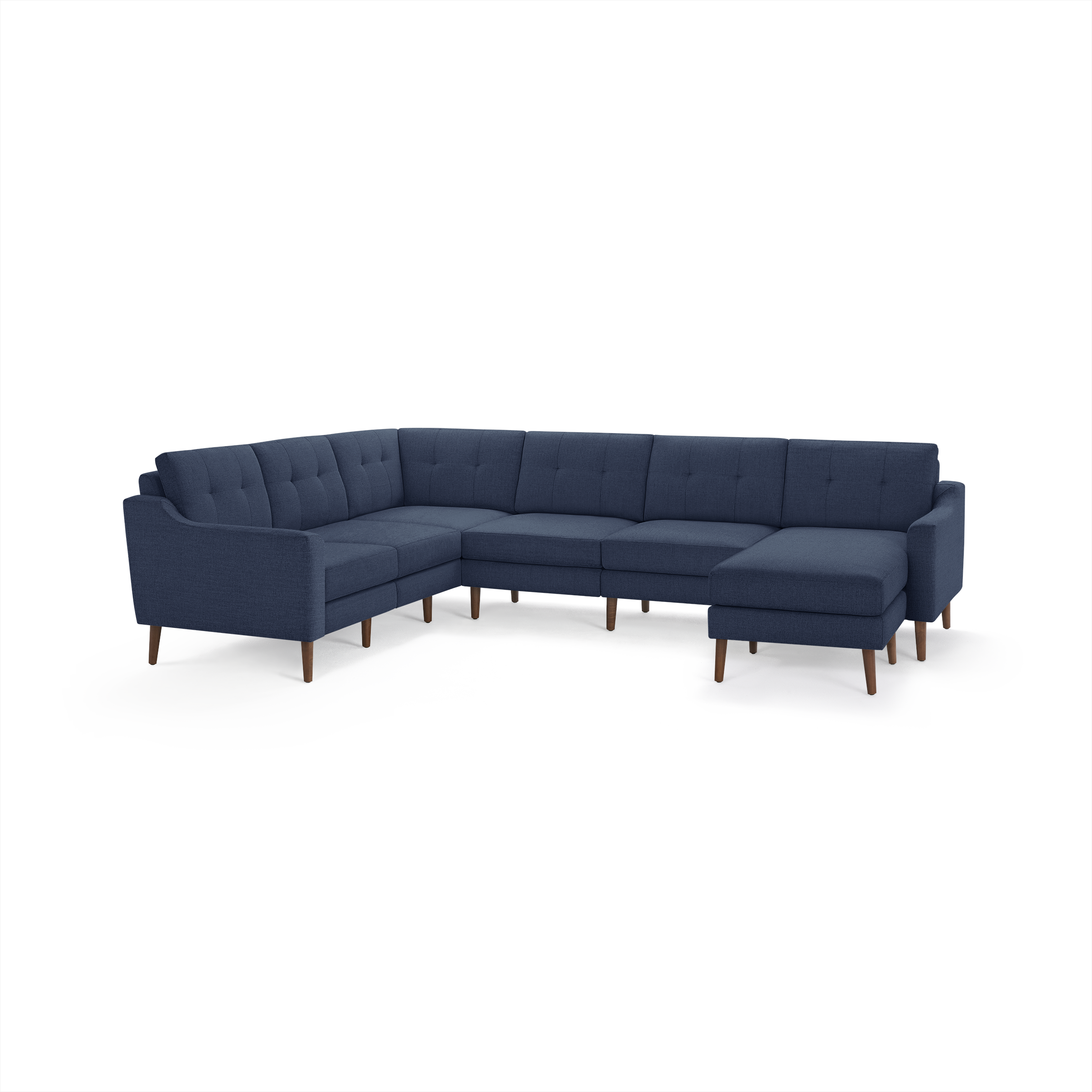 Large navy blue L-shaped sectional sofa with tufted back cushions and wooden legs on white background.