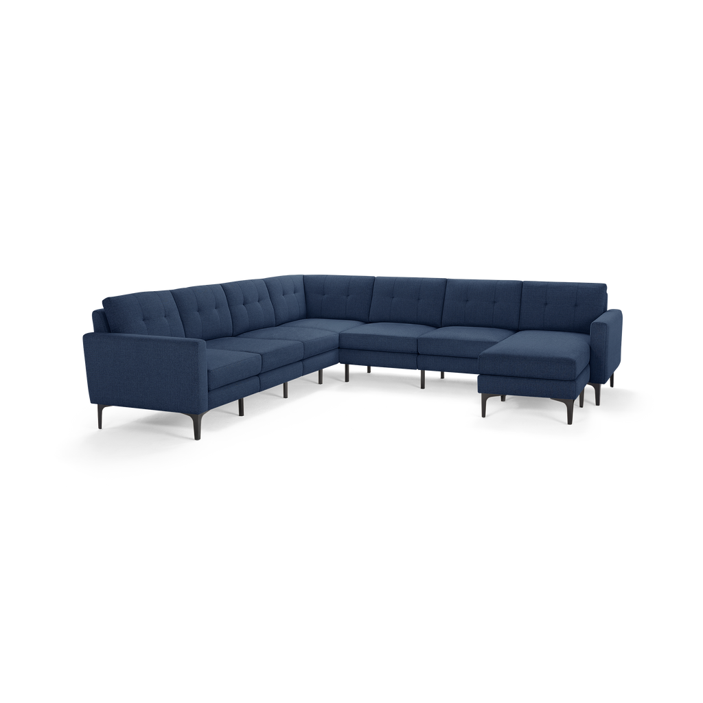 Modern navy blue sectional sofa with tufted cushions, sleek armrests, and metal legs, offering spacious corner seating.