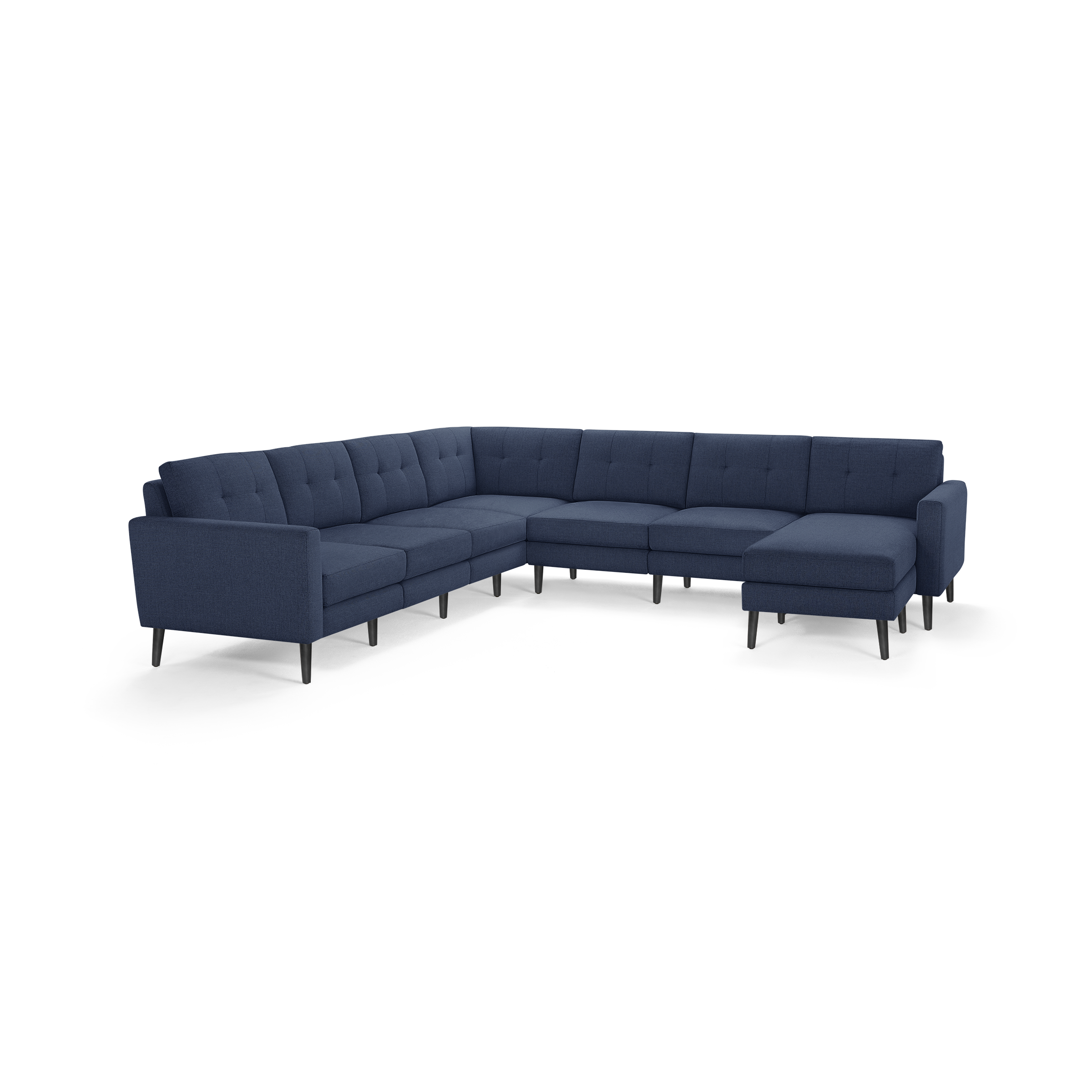 Large L-shaped sectional sofa upholstered in dark blue fabric with tufted back cushions and slim black legs.