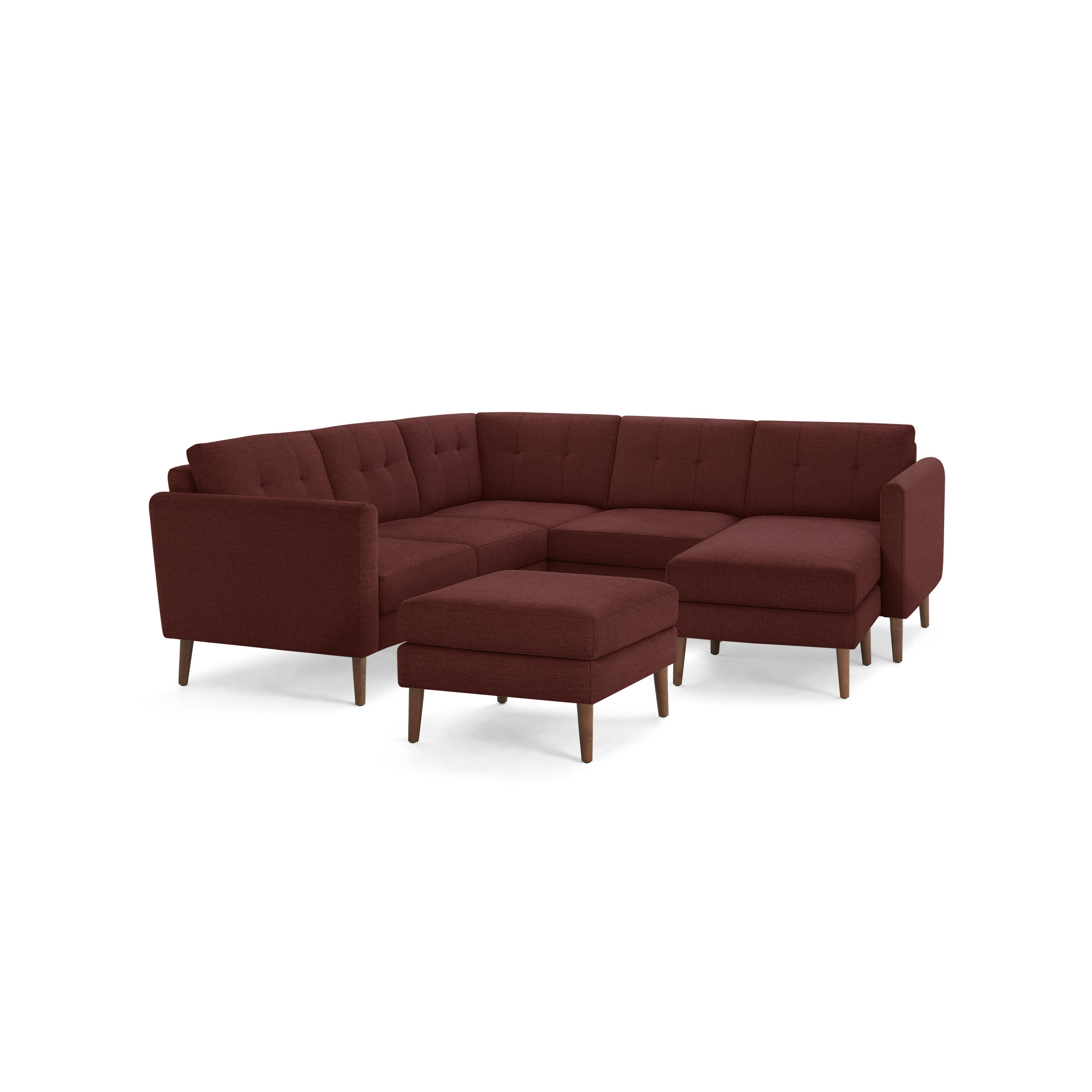Modern L-shaped sectional sofa in deep red fabric with tufted cushions and matching ottoman on wooden legs.
