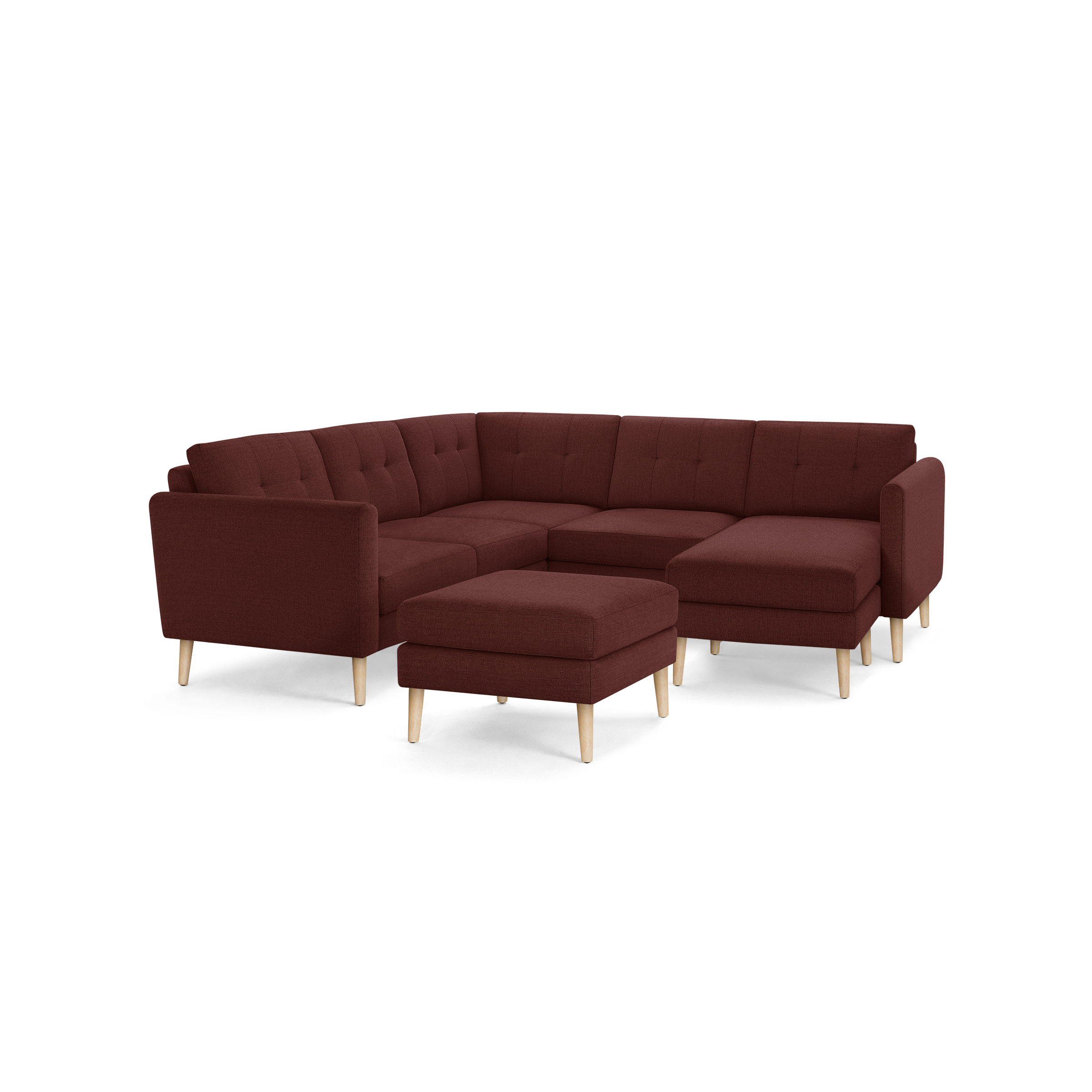 Modern L-shaped sectional sofa with deep red fabric upholstery, tufted back cushions, and light wooden legs, including a matching ottoman.
