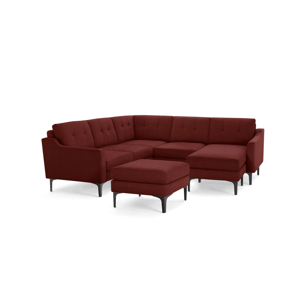 Modern sectional sofa in deep red fabric with tufted cushions, metal legs, and matching ottoman, designed for spacious seating.